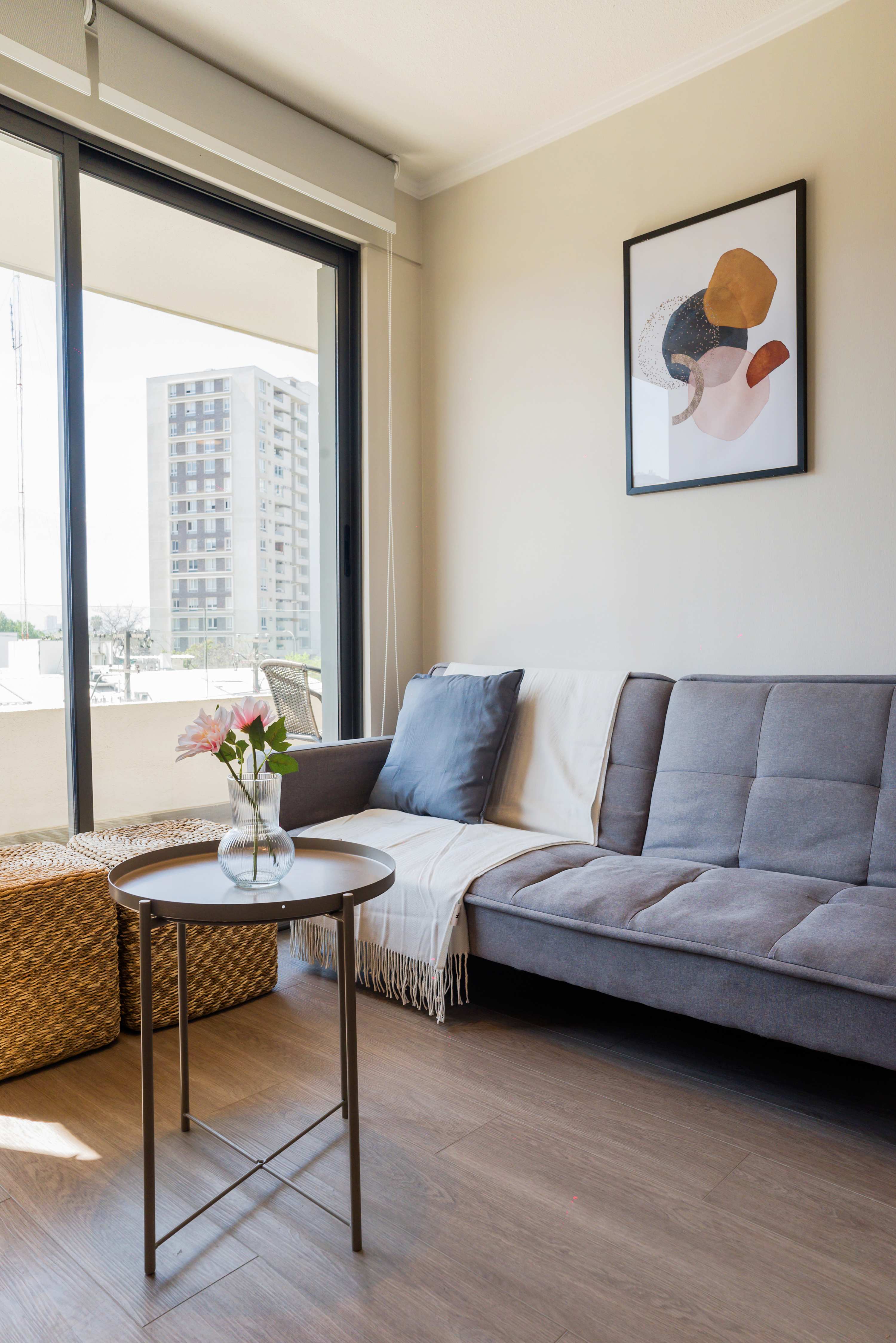 Relax in this bright and cozy living space with a stunning city view, perfect for unwinding after a day of exploring.