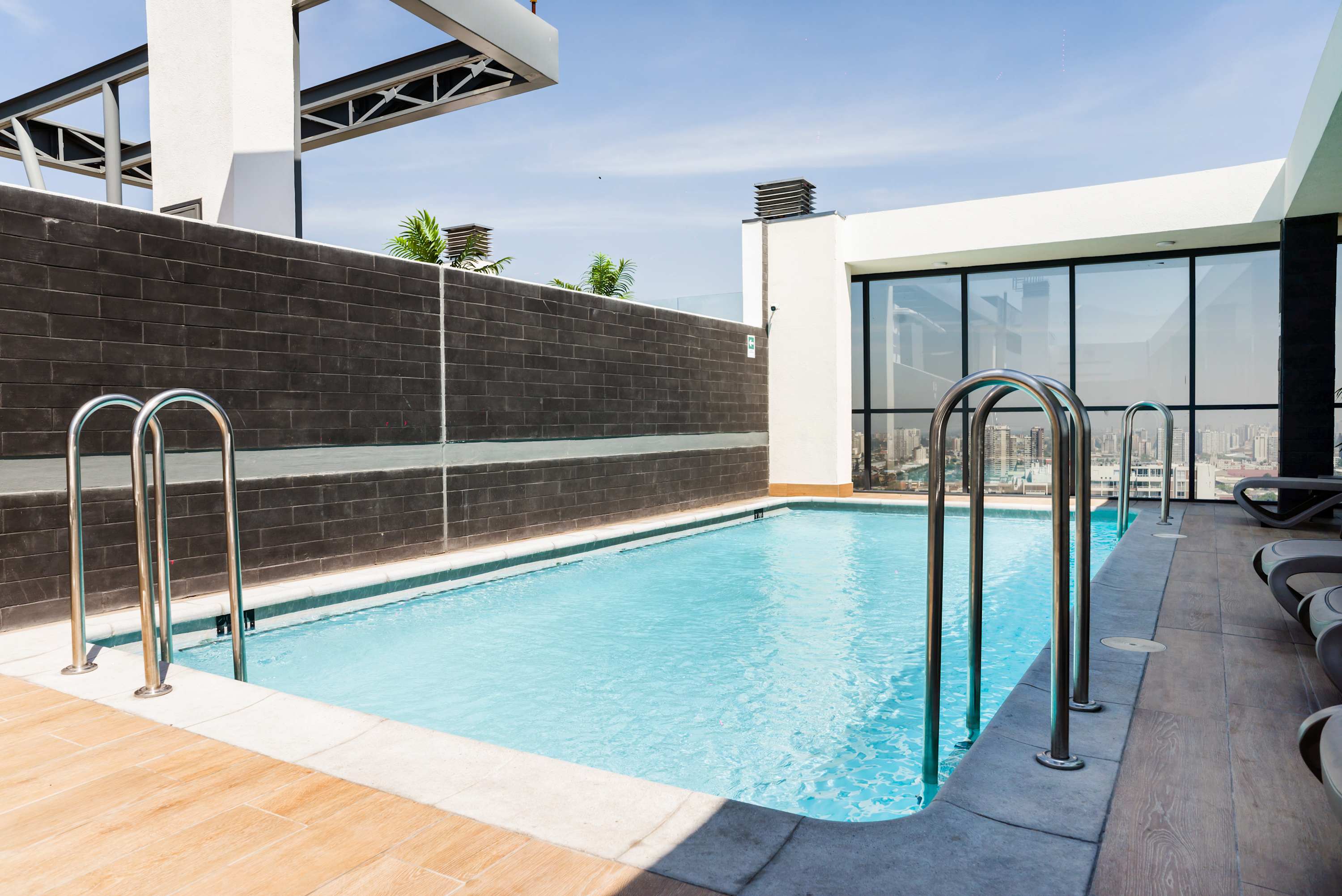 Enjoy a refreshing swim with stunning city views from this rooftop pool.