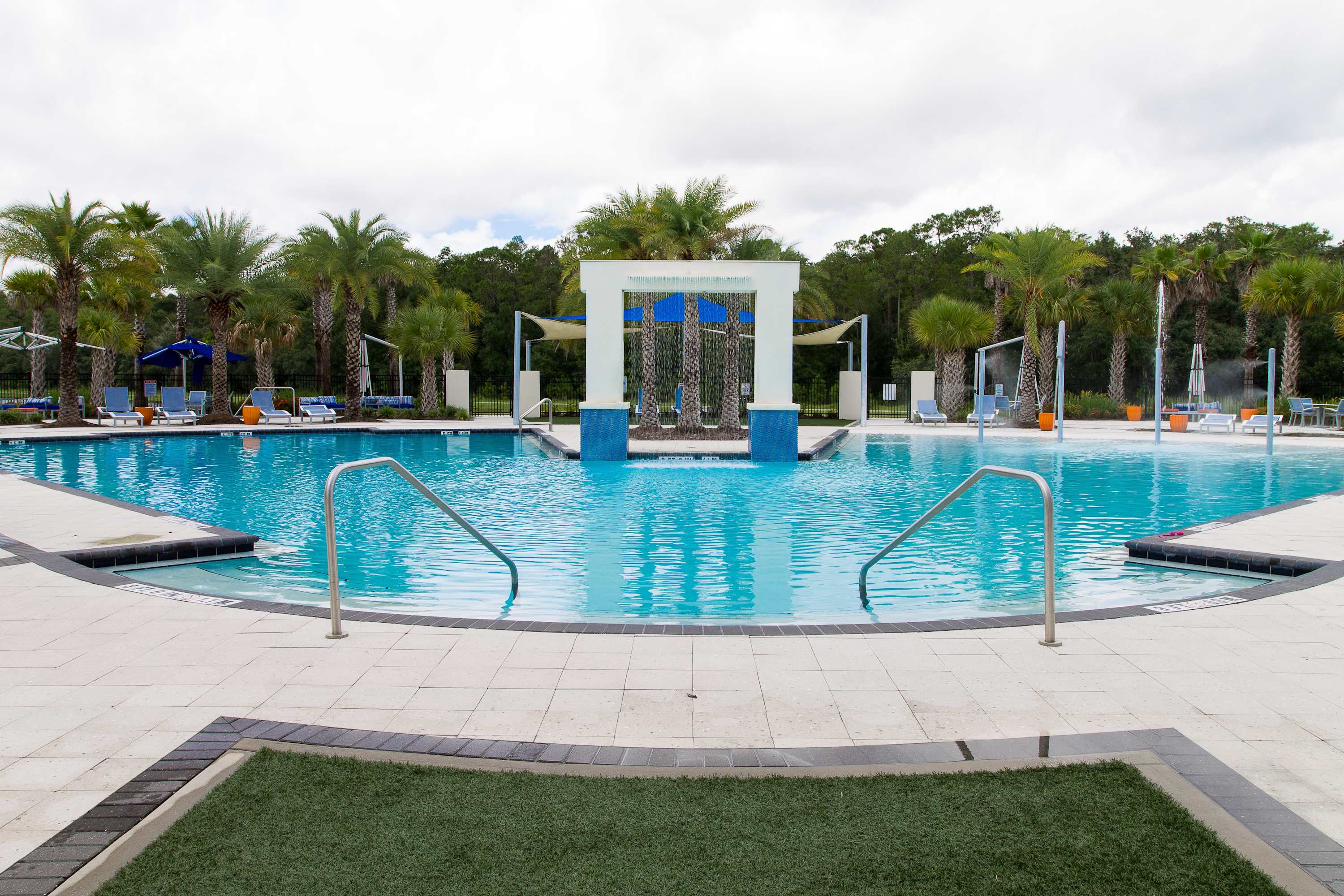 Main Resort Pool: Lounge in luxury at the zero-entry resort pool — perfect for sunbathing, swimming, or sipping cocktails poolside,