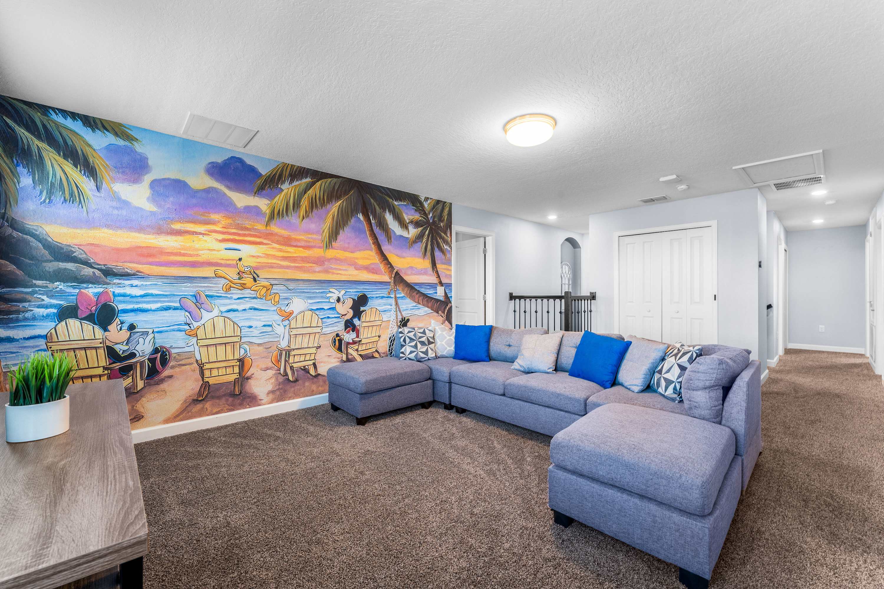 Disney themed loft with sectional seating and Smart TV