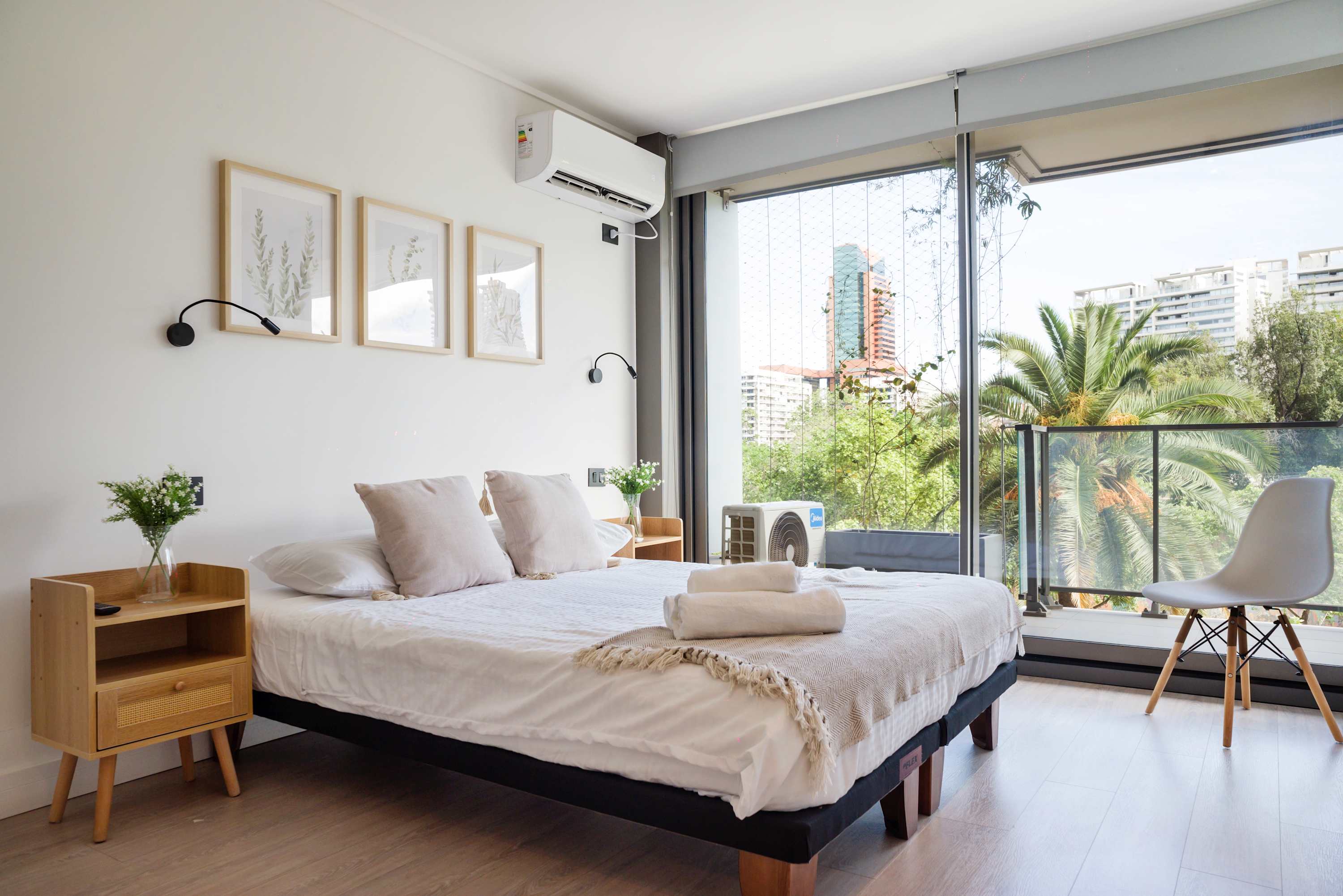 Relax in this serene bedroom with stunning city and garden views, perfect for unwinding after a day of exploring.