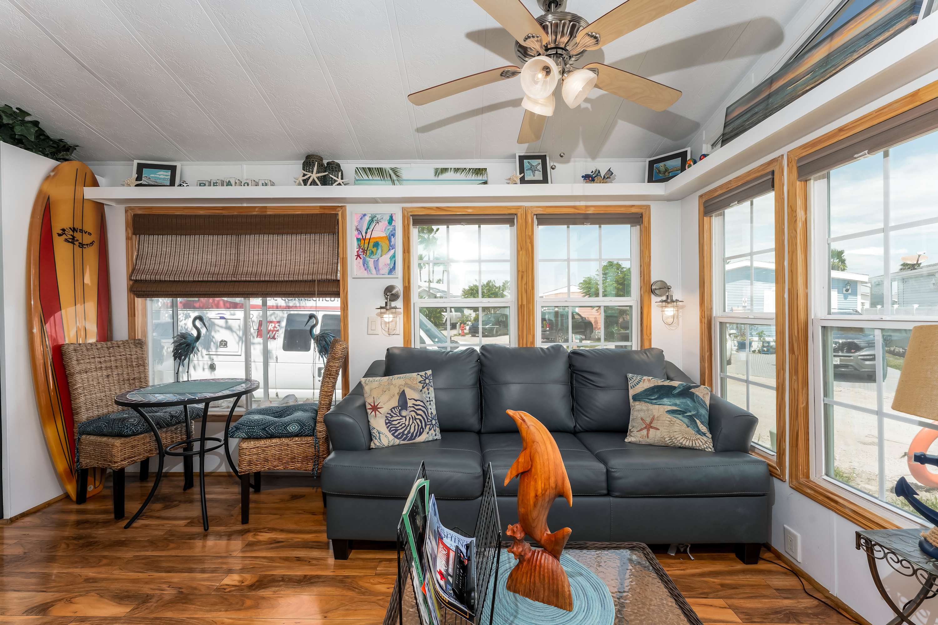 Bright Living Room – Relax in a sun-filled space with large windows, a sofa bed, comfortable seating, and canal views.