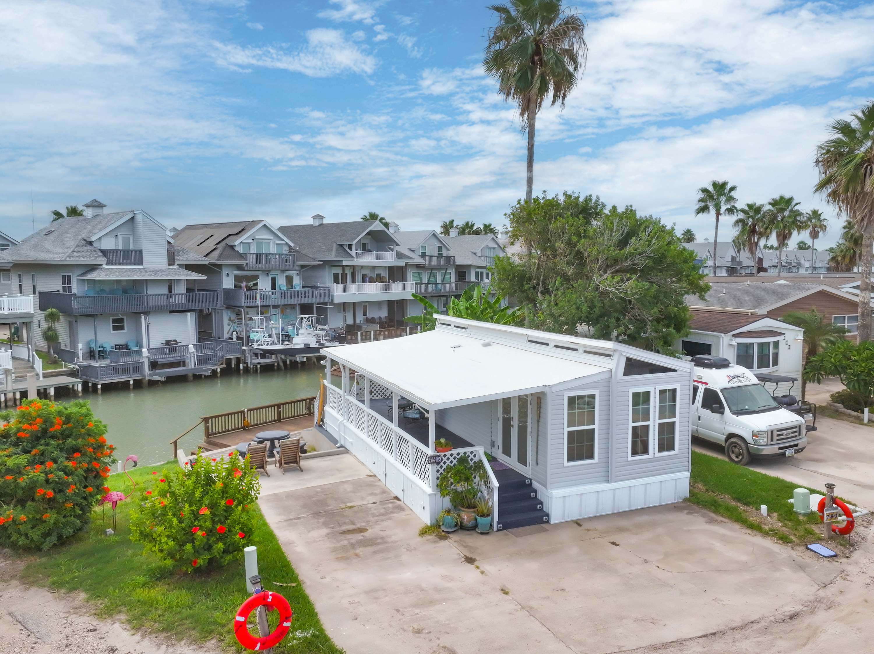 Aerial View of the Home – Nestled along the waterway with lush landscaping and close to resort amenities.