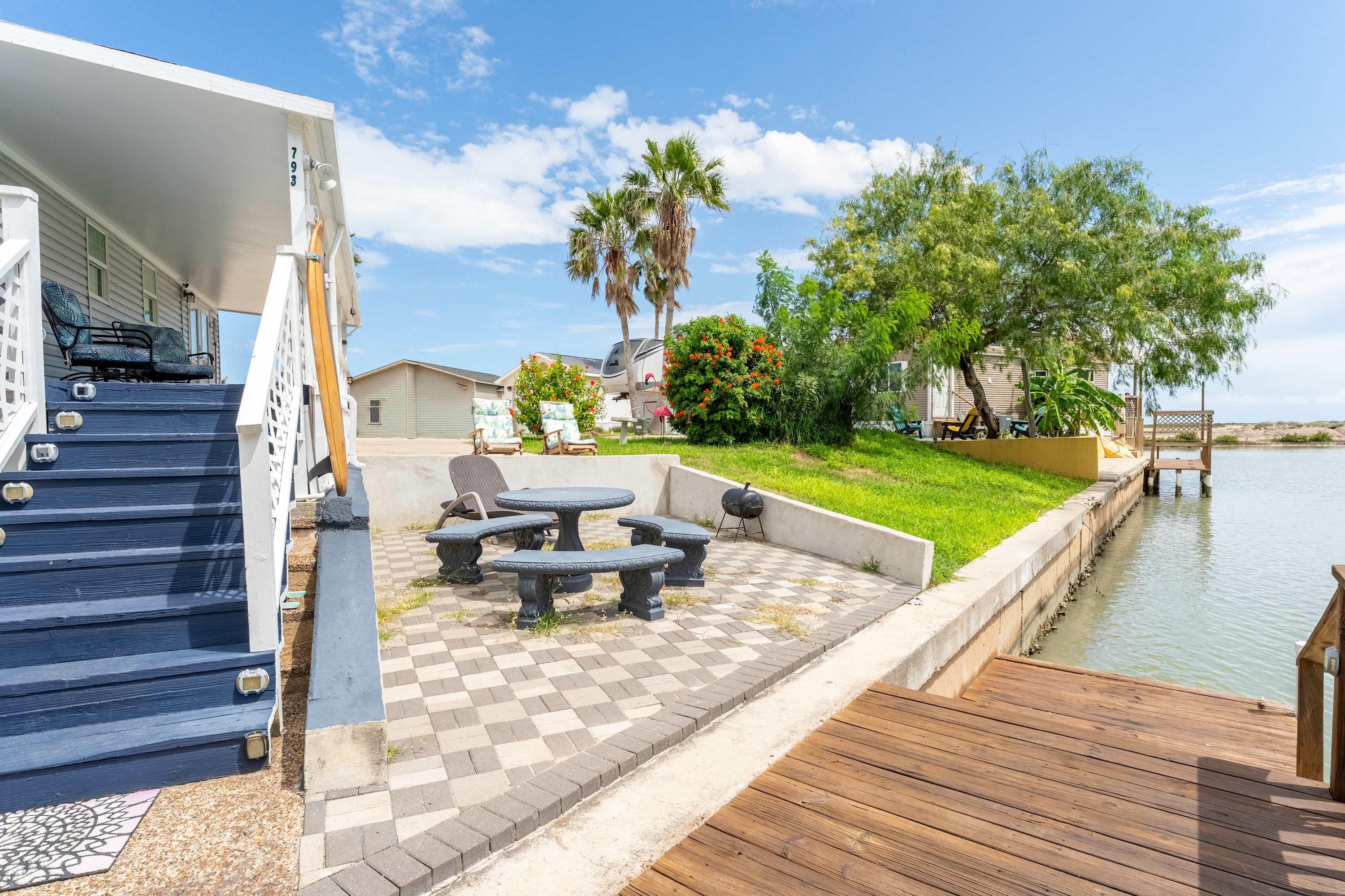 Outdoor Stair Access – Easy access between the deck and lower patio levels for lounging or fishing.