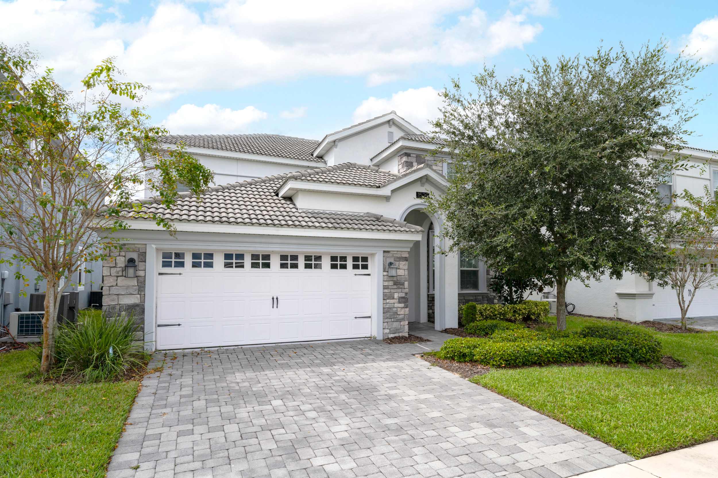 Spacious villa with modern design and lush landscaping, perfect for a relaxing getaway.