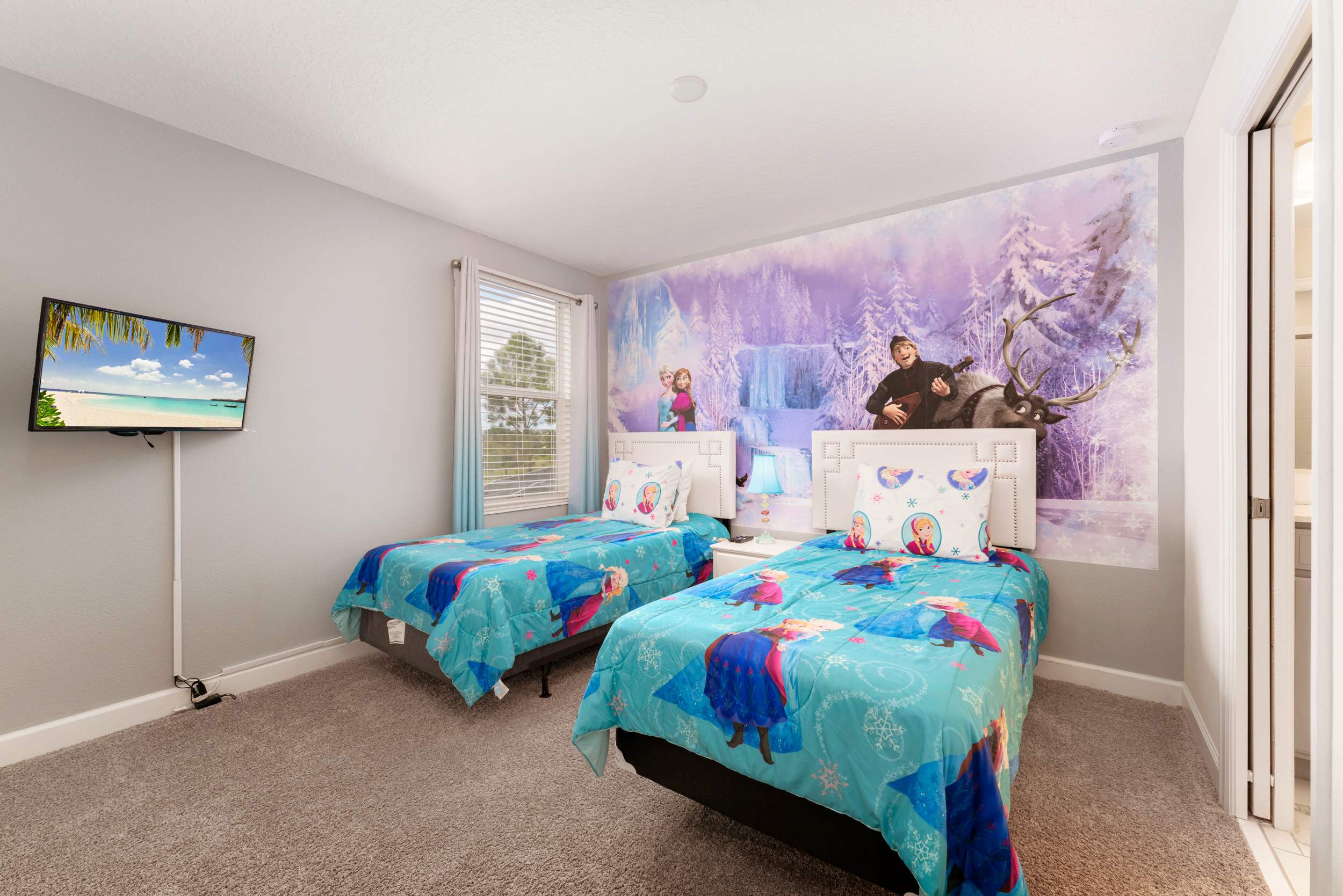 Delight the kids with this enchanting themed bedroom, complete with vibrant decor and cozy twin beds.