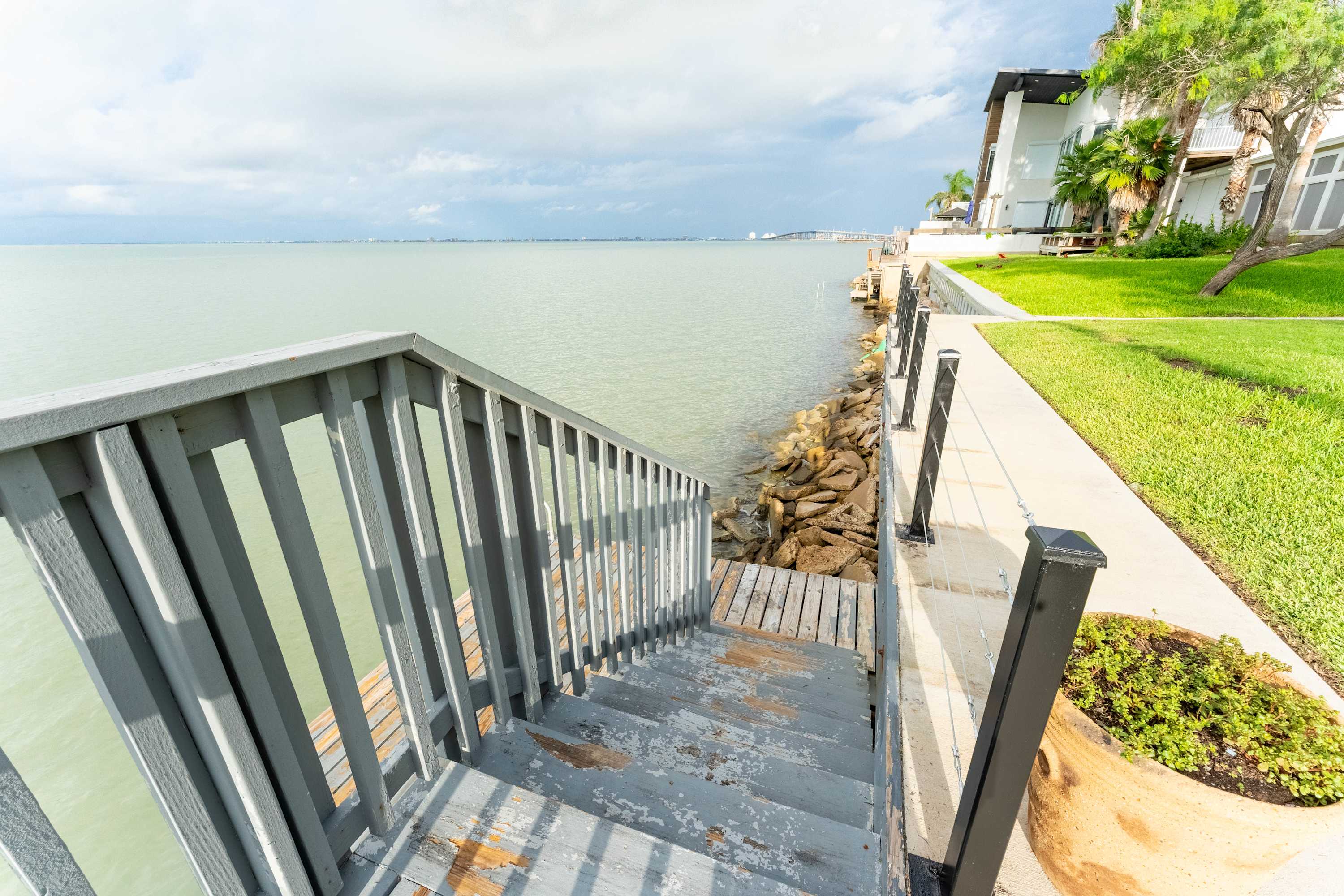 Lawn & Dock Access — Step directly onto the grassy waterfront and enjoy easy access to the dock and walking paths along the shore.