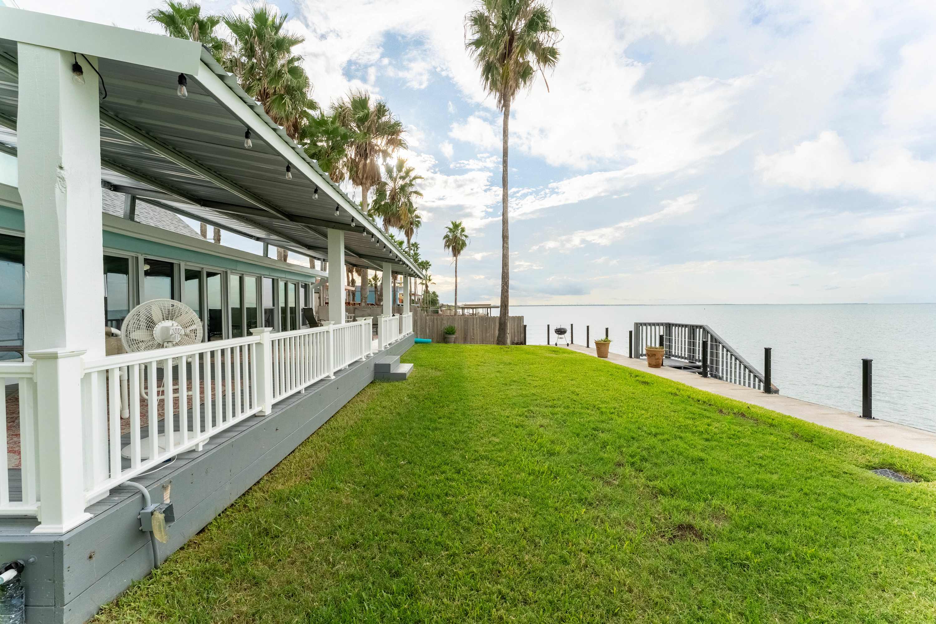 Lawn & Dock Access — Step directly onto the grassy waterfront and enjoy easy access to the dock and walking paths along the shore.