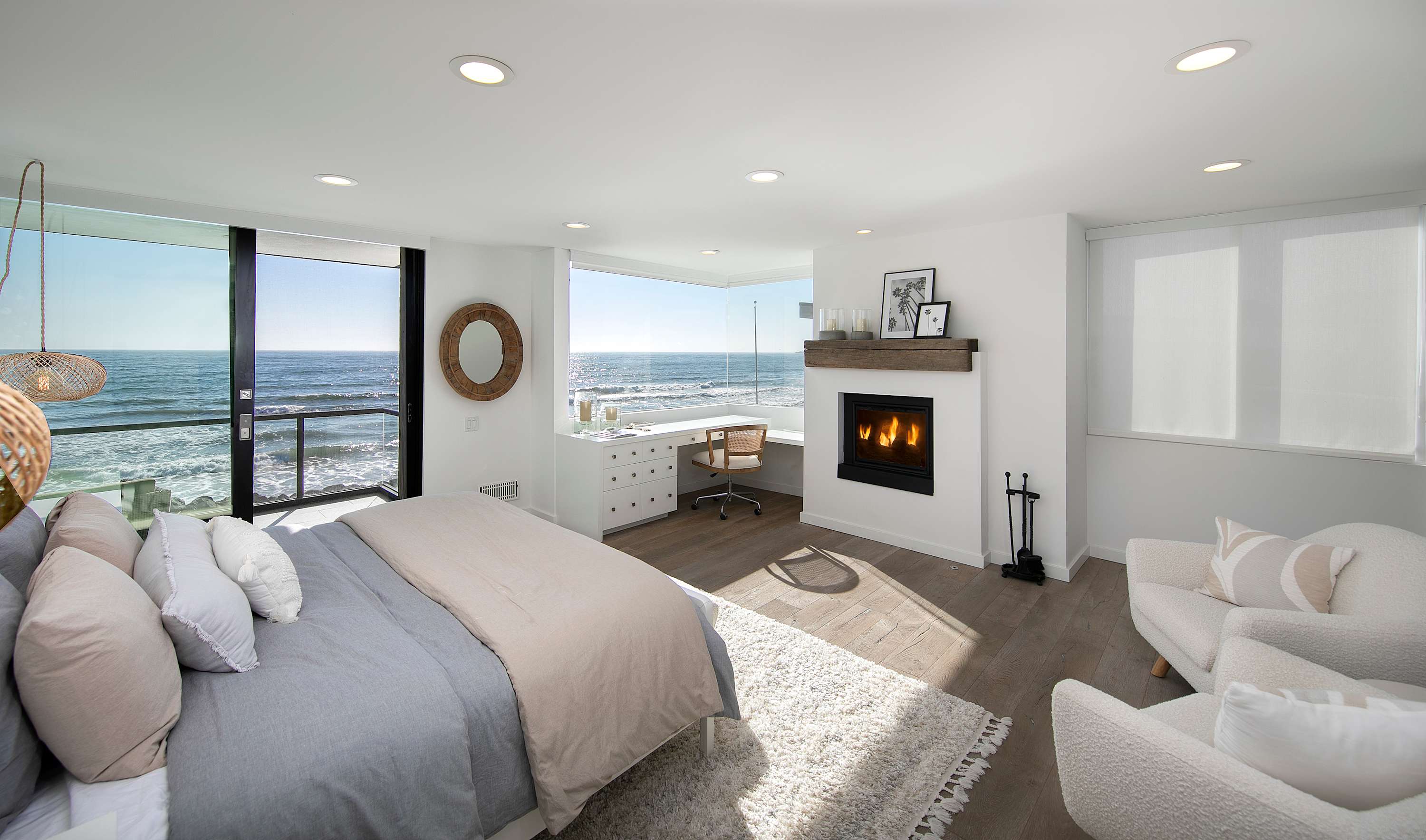 King suite retreat with fireplace, balcony, and ocean-view workspace