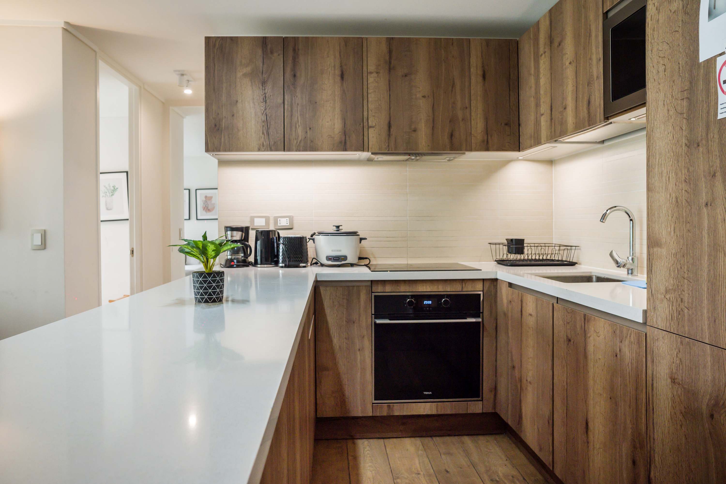 Modern kitchen with sleek wooden cabinetry and all essentials for a delightful cooking experience.
