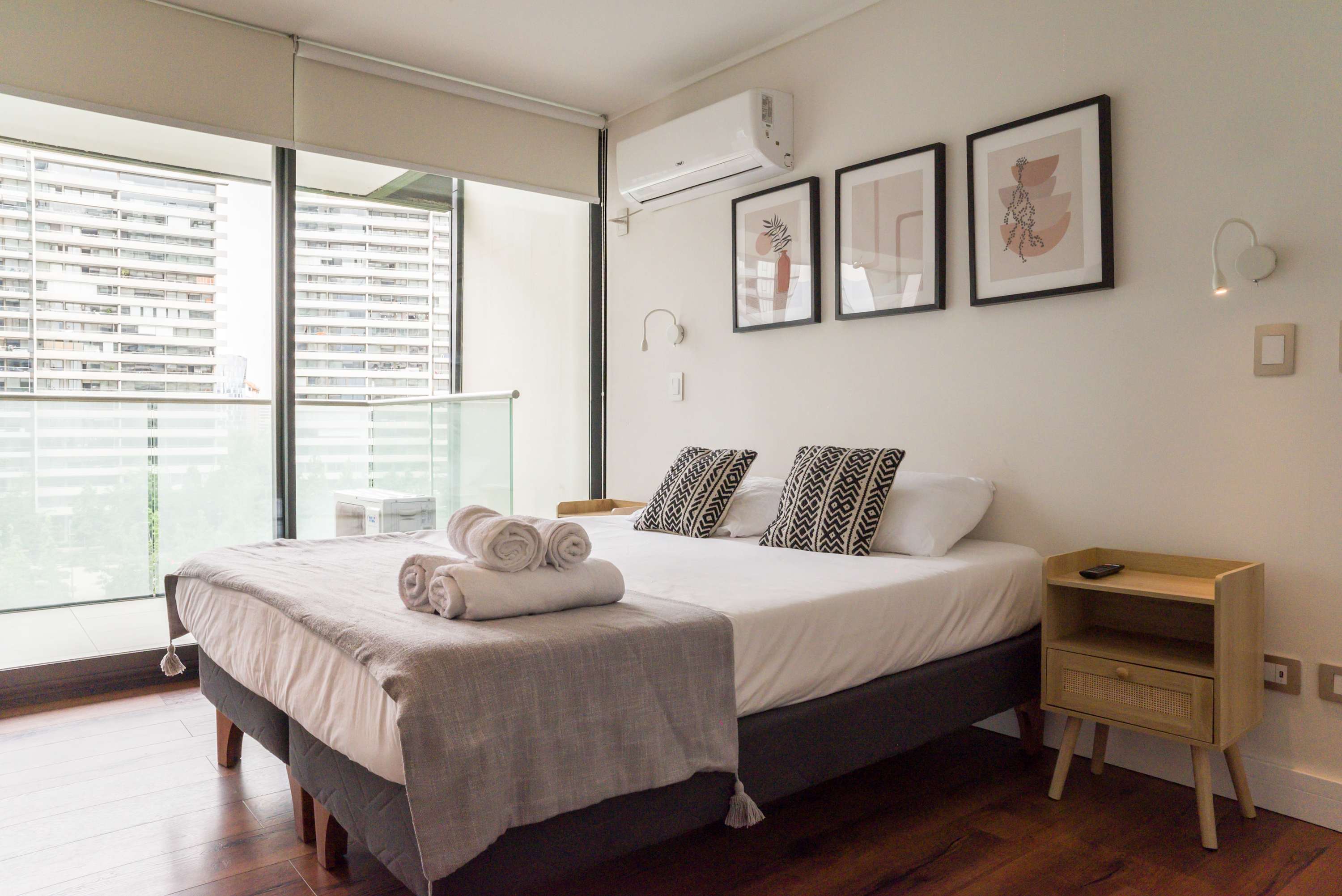 Unwind in this chic bedroom with a cozy bed and balcony views, perfect for relaxation after exploring the city.