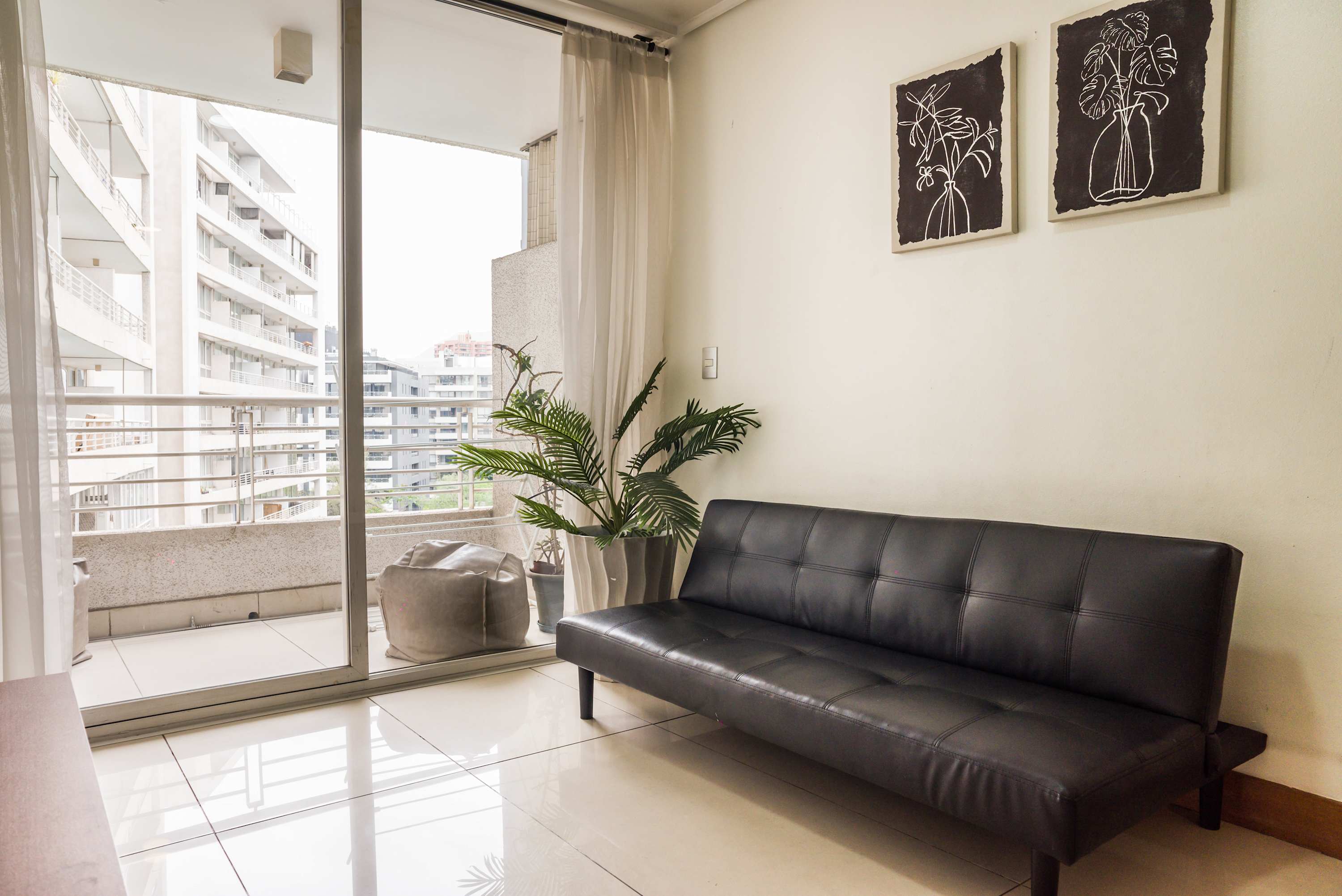 Bright and cozy living area with balcony access, perfect for relaxing after exploring the city.