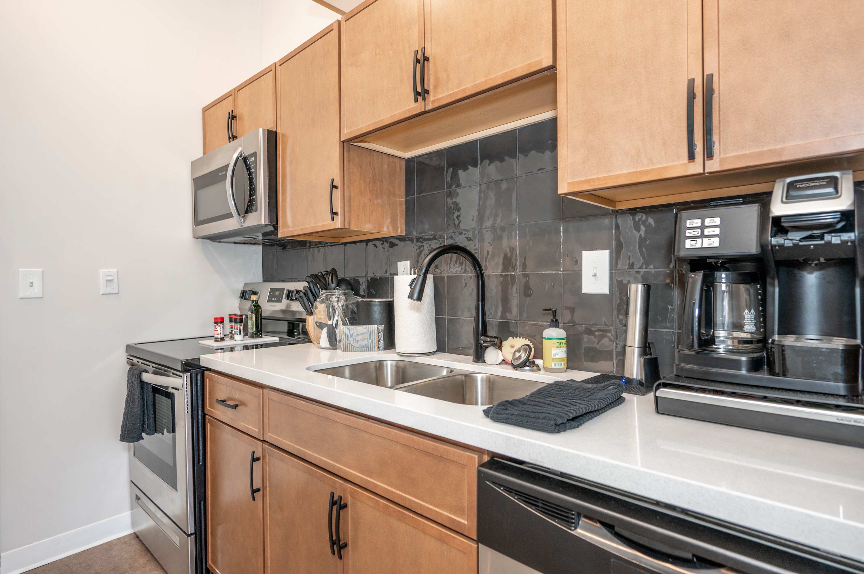 The sleek, open kitchen offers ample storage & every home comfort​