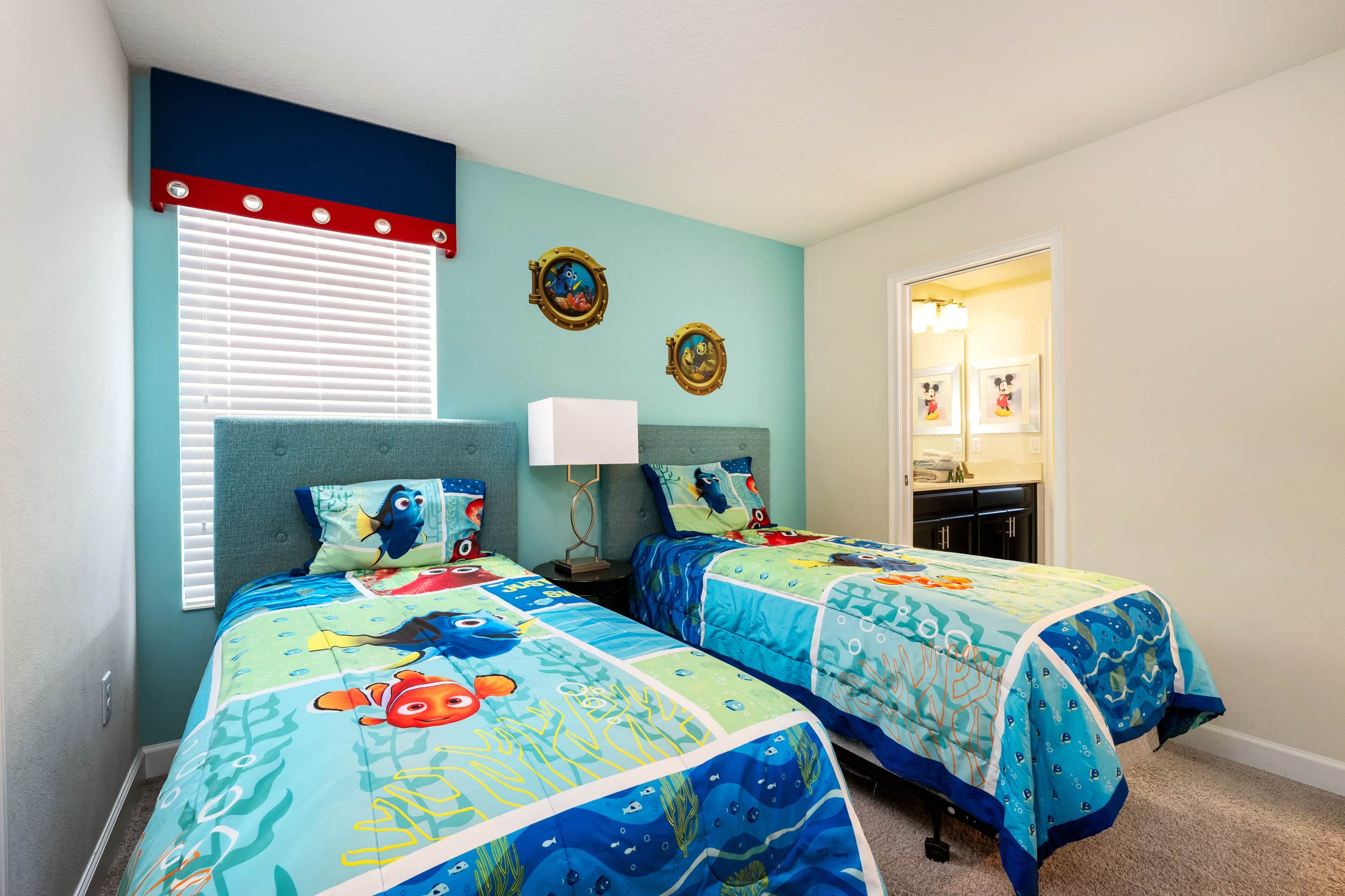 Dive into adventure in this 'Finding Nemo' themed bedroom, perfect for kids and families. Enjoy vibrant decor and easy bathroom access.