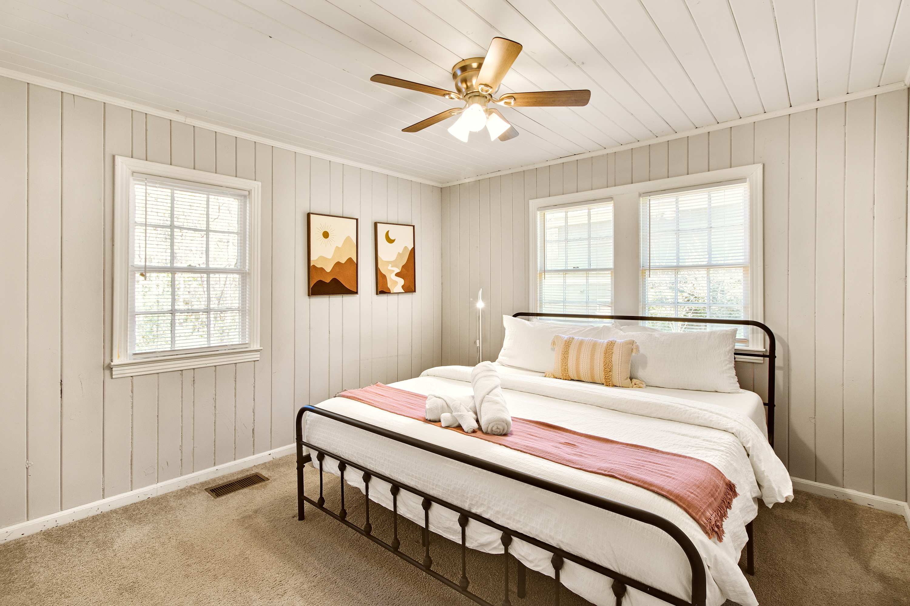Cozy bedroom retreat with natural light and modern decor, perfect for a restful stay.
