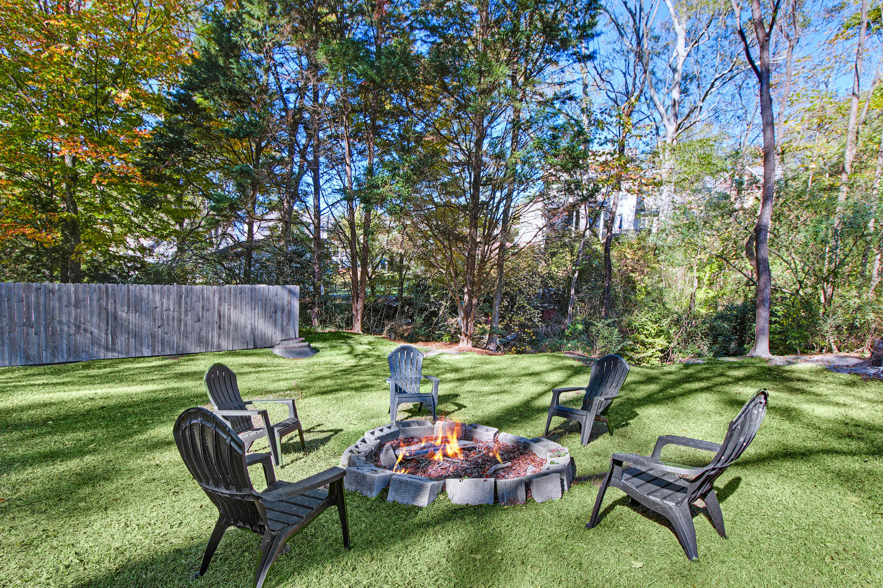 Relax by the cozy fire pit in this serene outdoor space, perfect for evening gatherings under the stars.