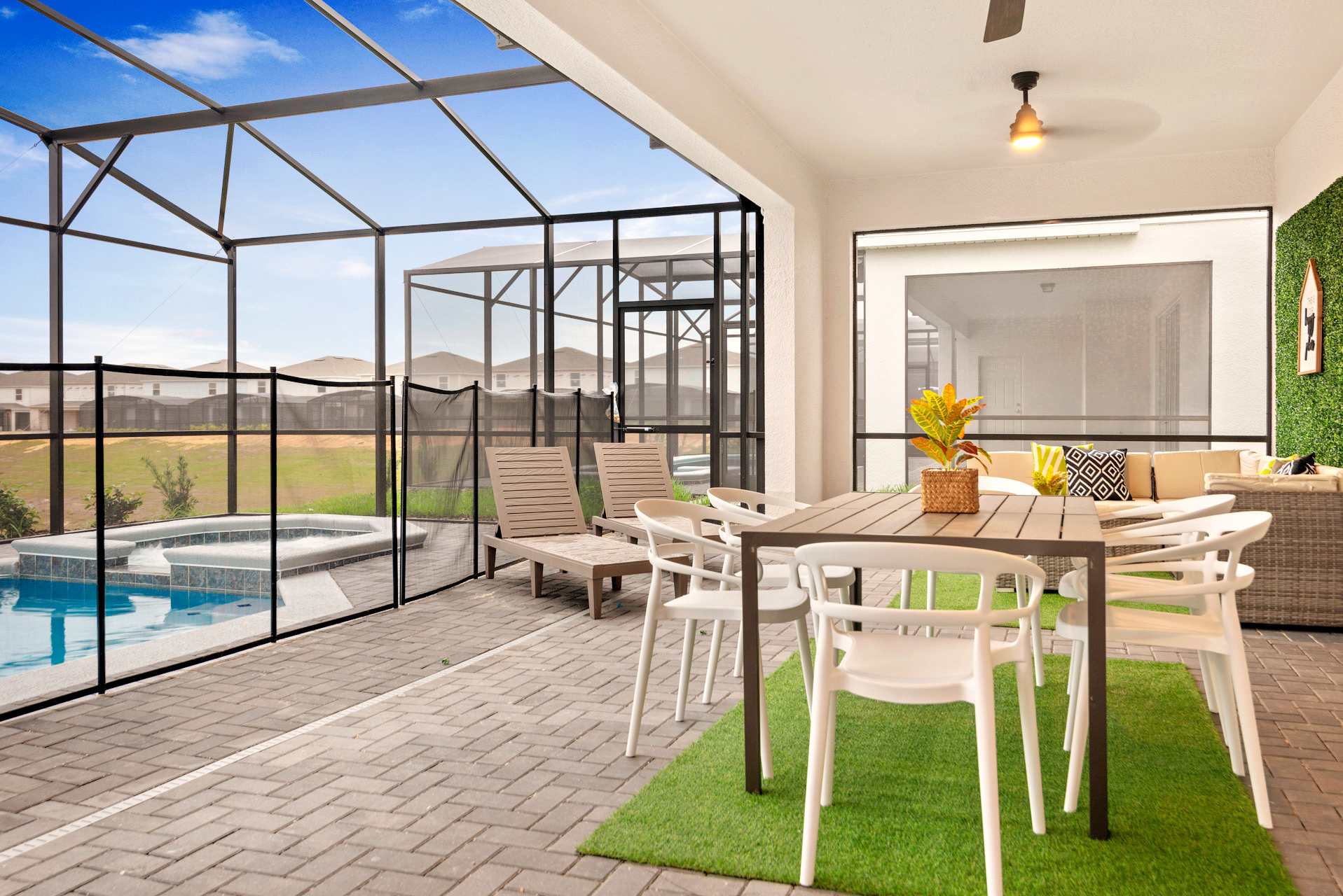 Relax on the spacious screened patio with dining area and pool access, perfect for outdoor gatherings.