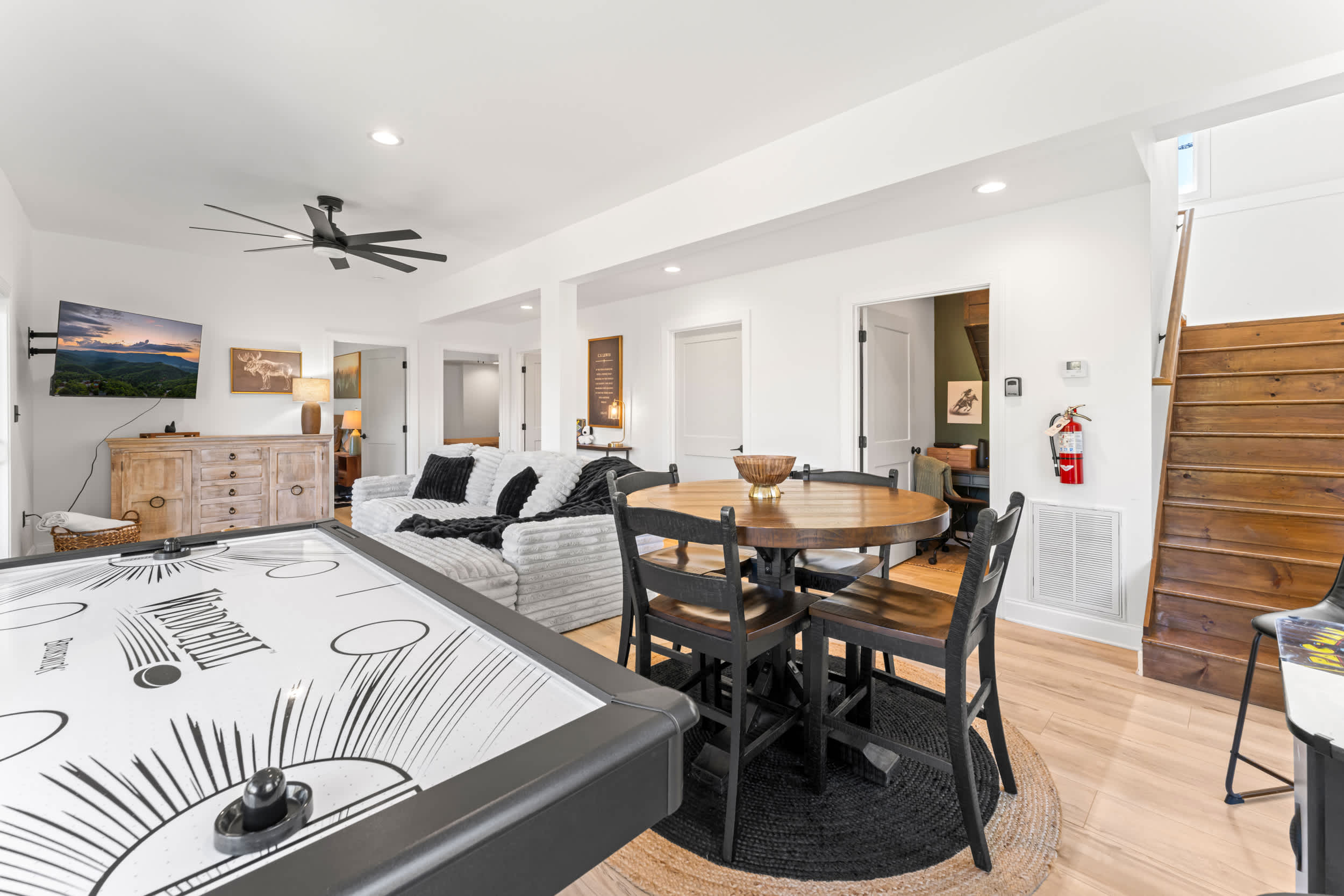 Game Room (lower level): Games, smart TV, plush seating, and deck access.