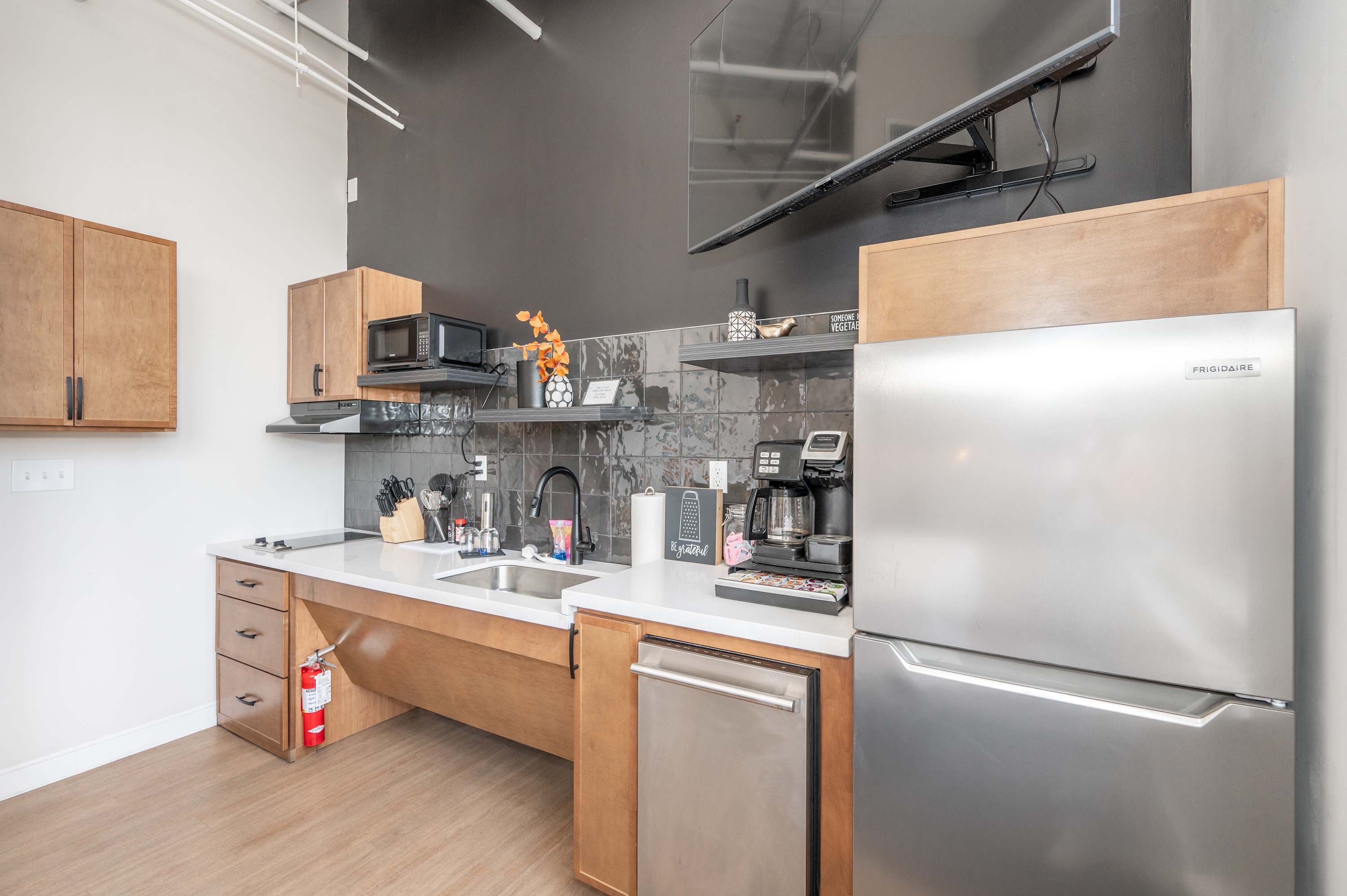 The sleek, open kitchen is equipped with all the comforts of home​