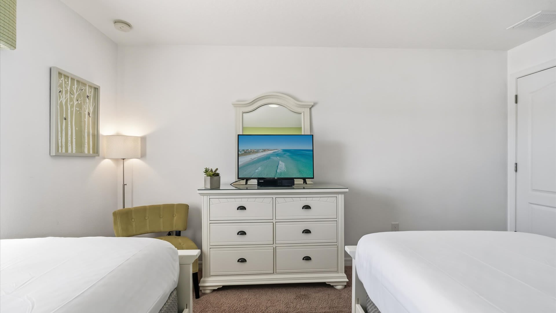 Vibrant Twin Bedroom for peaceful nights with a smart TV.