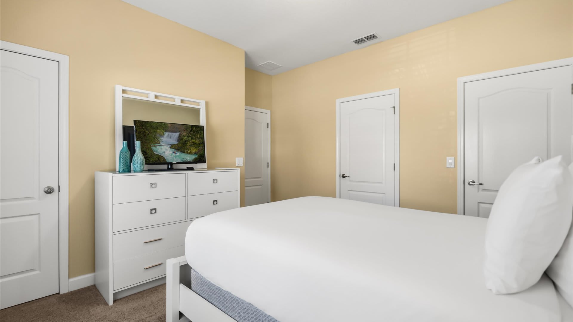 Peaceful and stylish room with a queen bed and shared bathroom access.