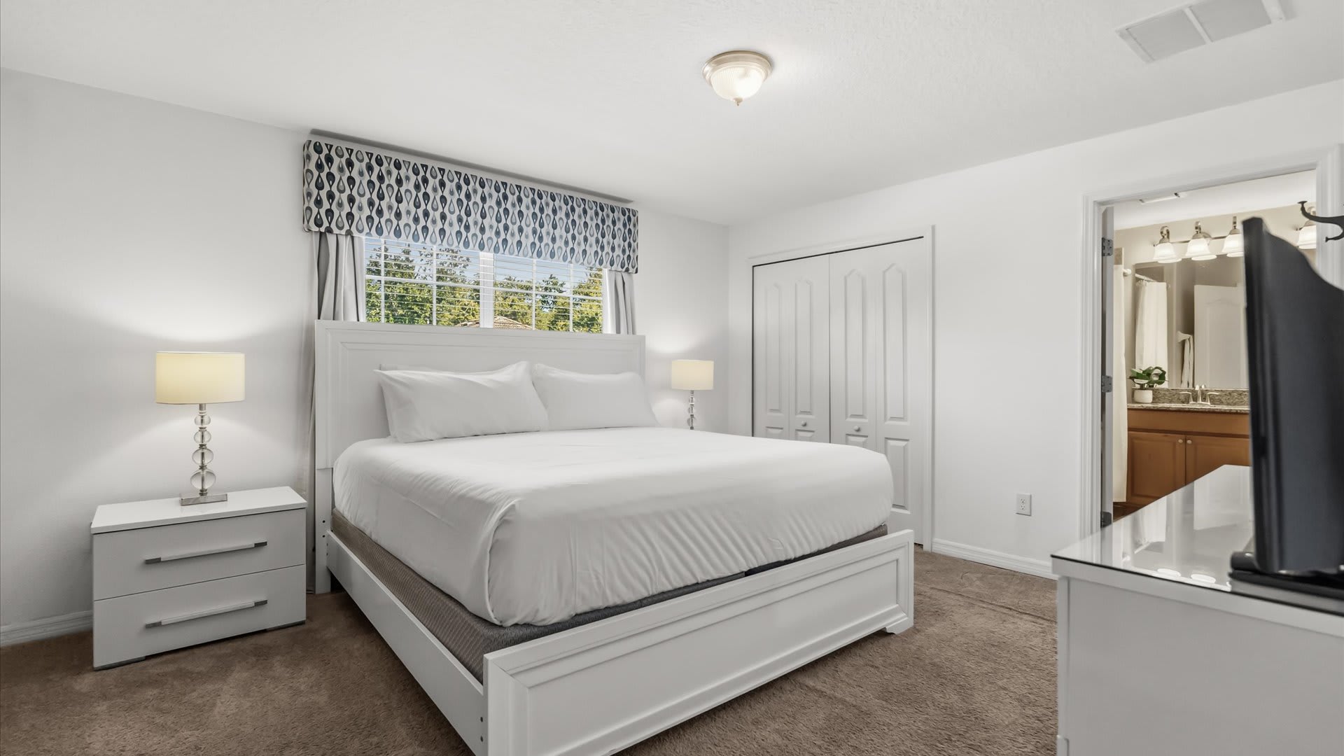 Stylish master suite with a king bed, private ensuite bathroom, and TV for ultimate relaxation.