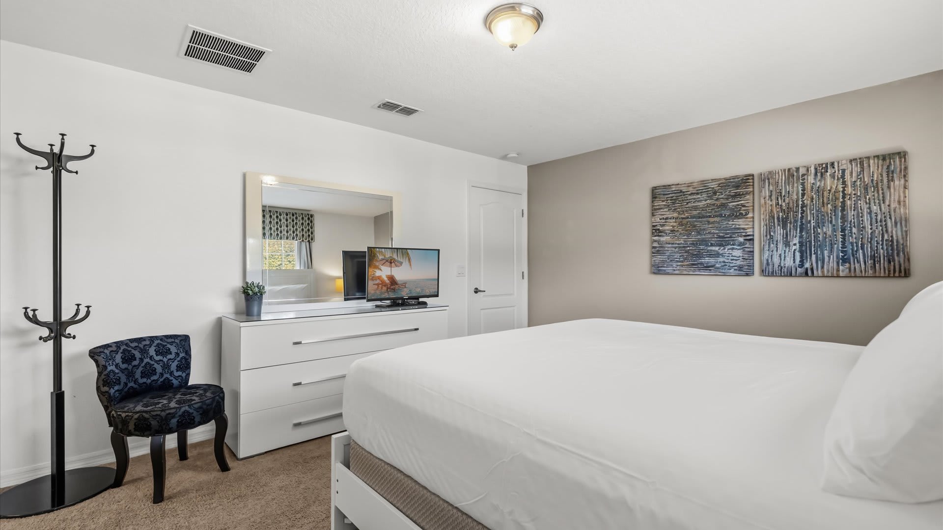 Stylish master suite with a king bed, private ensuite bathroom, and TV for ultimate relaxation.
