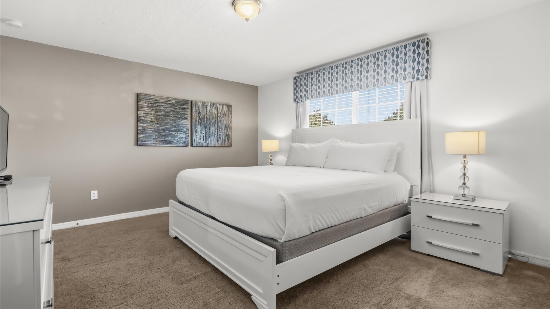 Stylish master suite with a king bed, private ensuite bathroom, and TV for ultimate relaxation.