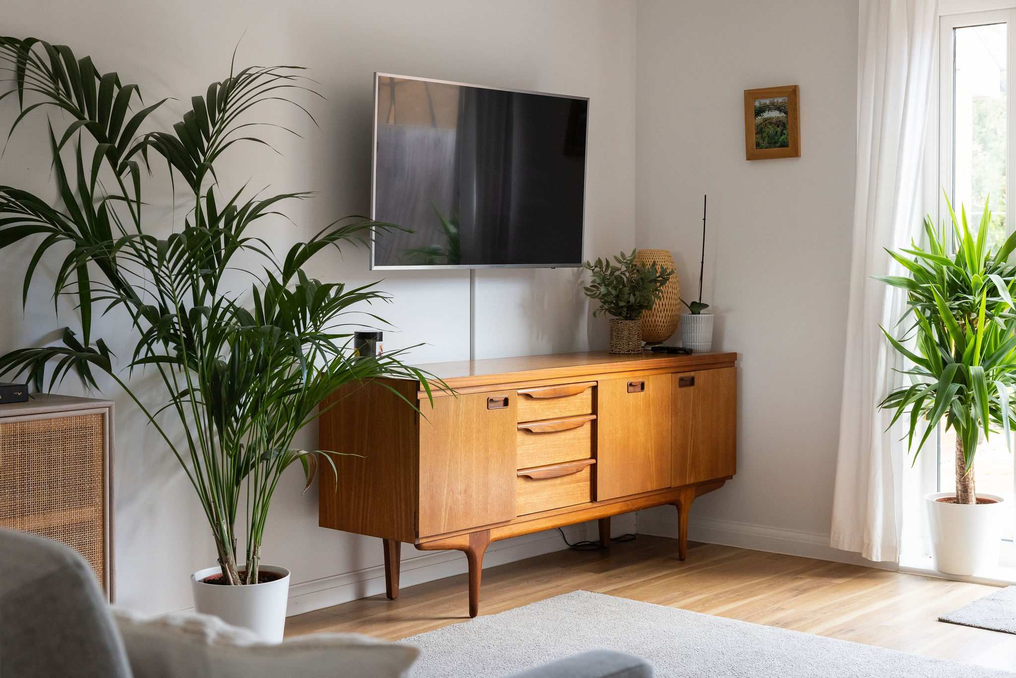Living area with 50" Smart TV and doors to the sunny garden.