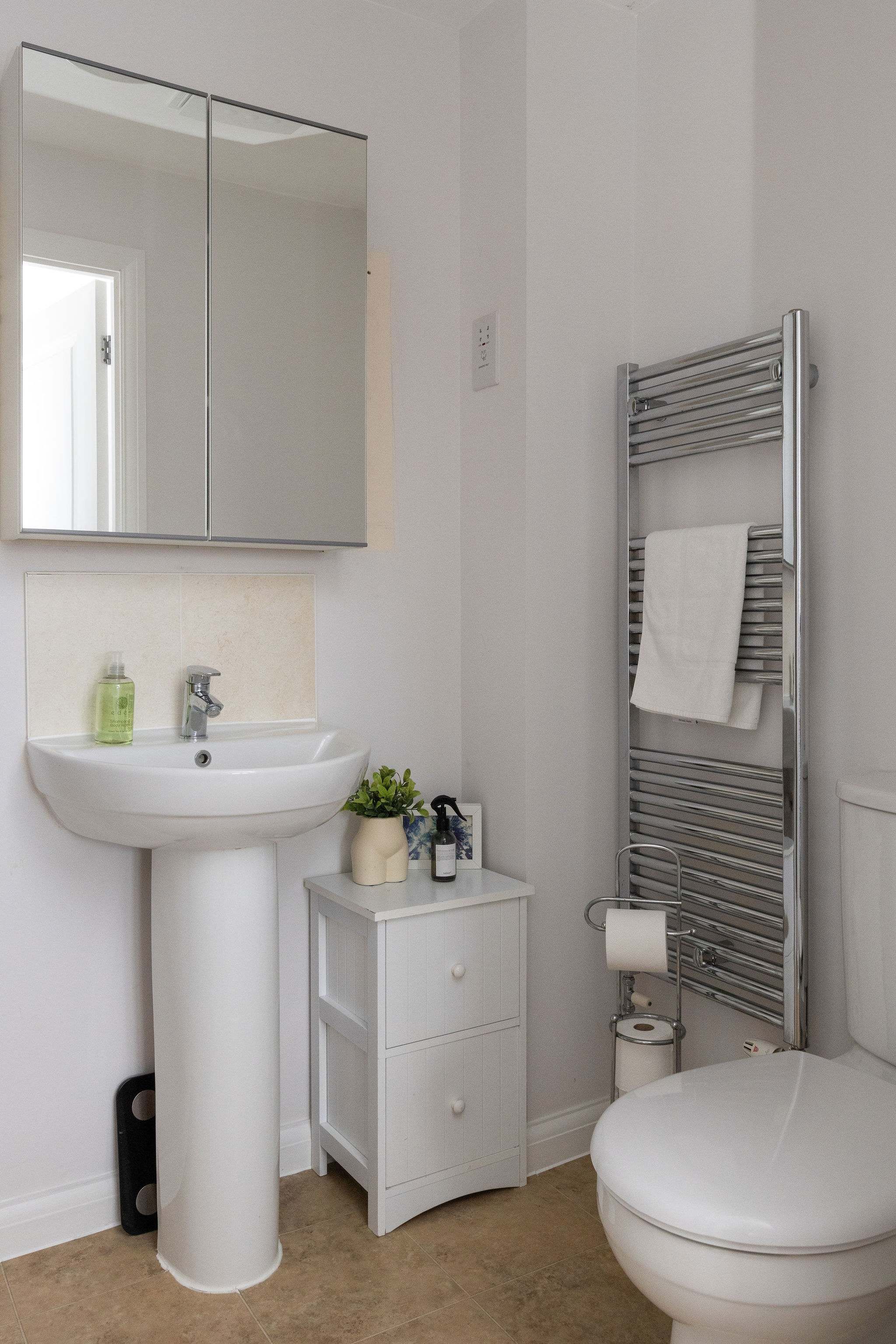 Bright ensuite with heated towel rail.