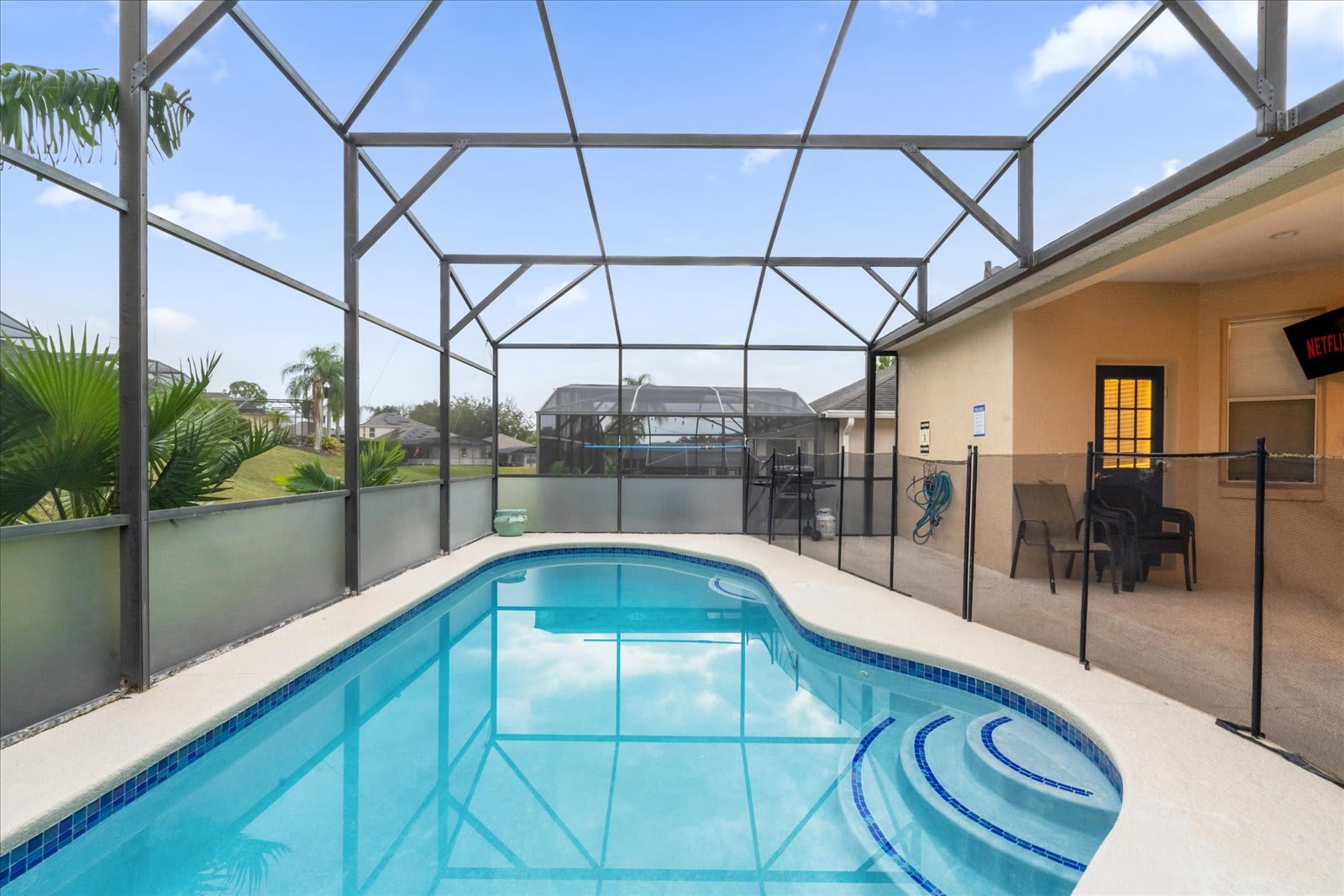 Relax in your private screened pool oasis, perfect for a refreshing dip or lounging under the Florida sun.