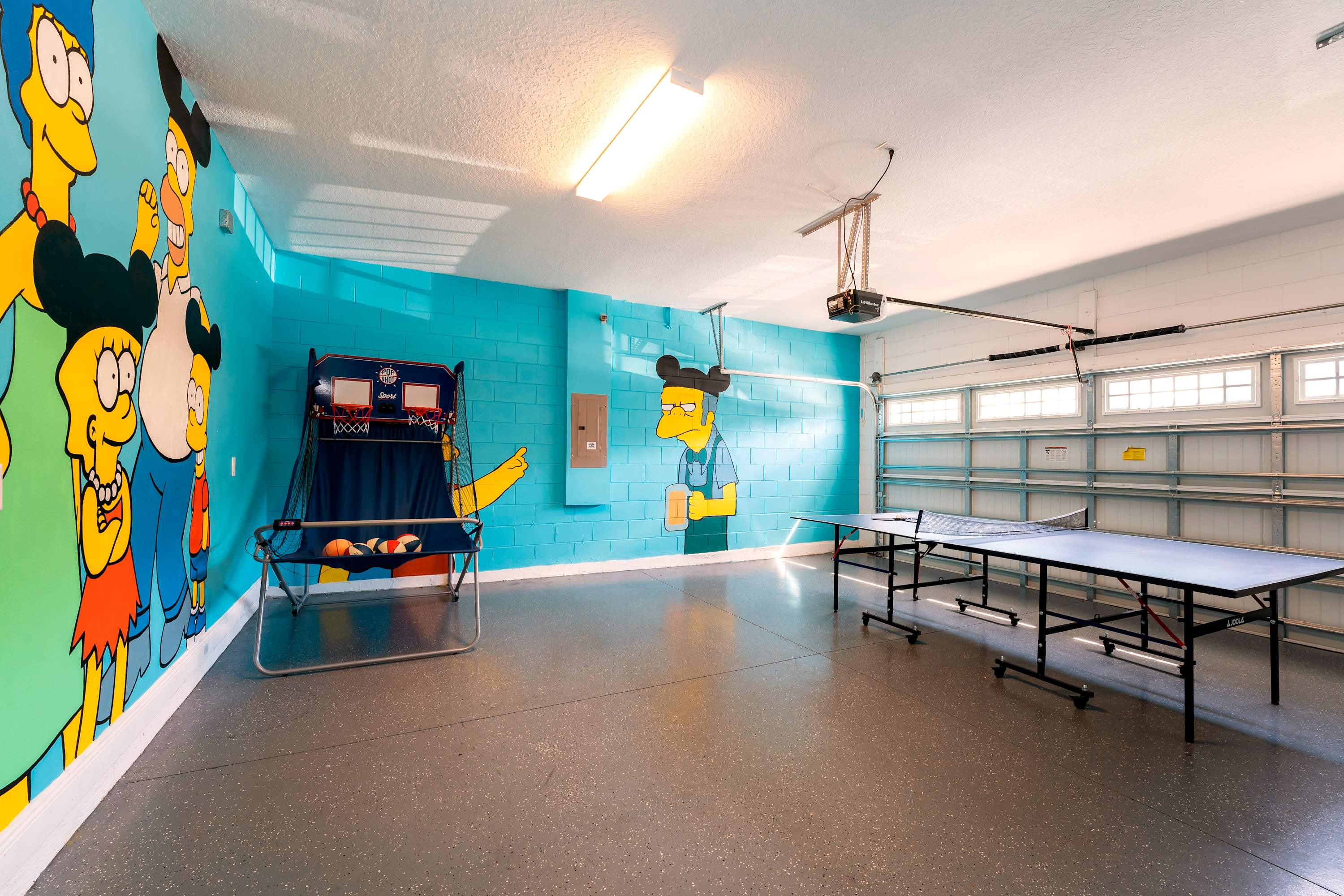 Dive into fun in this colorful game room with arcade basketball and ping pong, perfect for family entertainment.