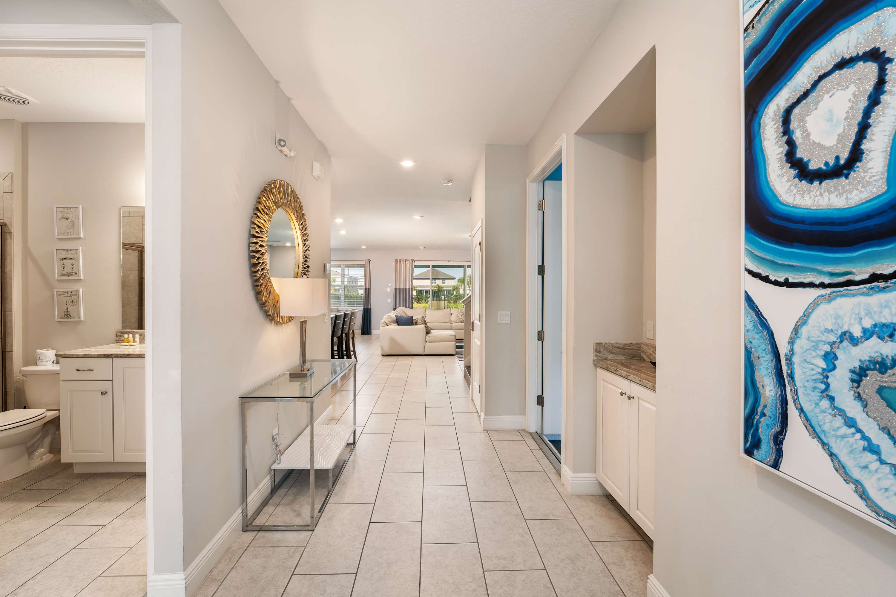 Stylish entryway with chic decor leading to a spacious living area, perfect for welcoming gatherings.