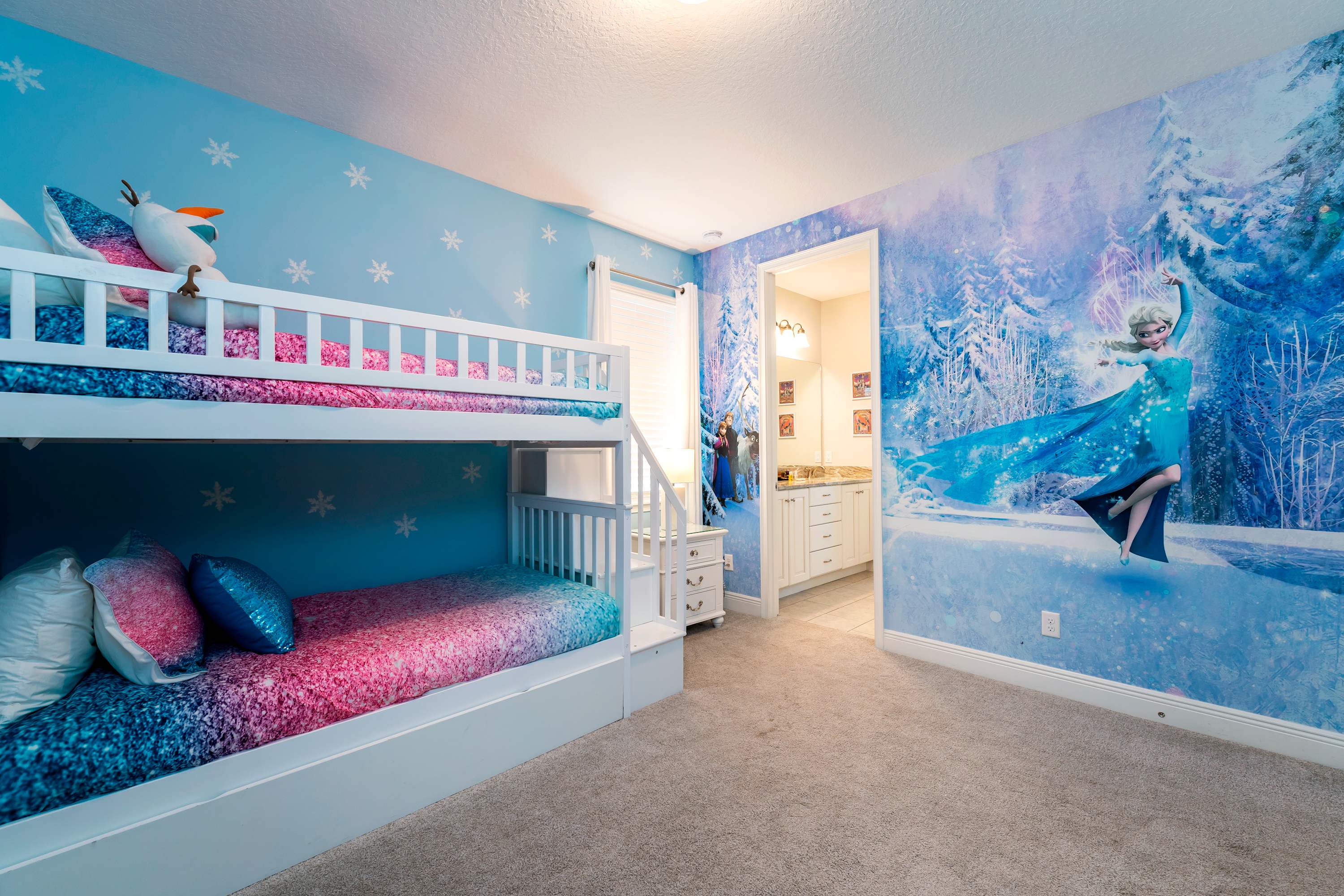 Experience a Frozen-themed wonderland with vibrant bunk beds and an enchanting Elsa mural, perfect for young adventurers!