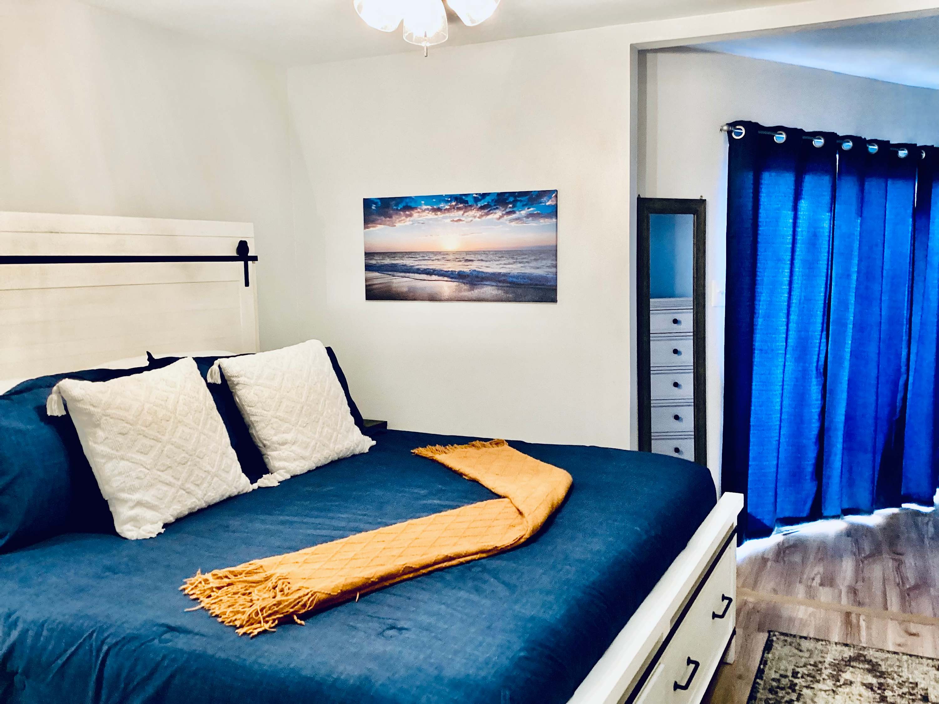 Bedroom 1 with king bed, balcony, and Smart TV