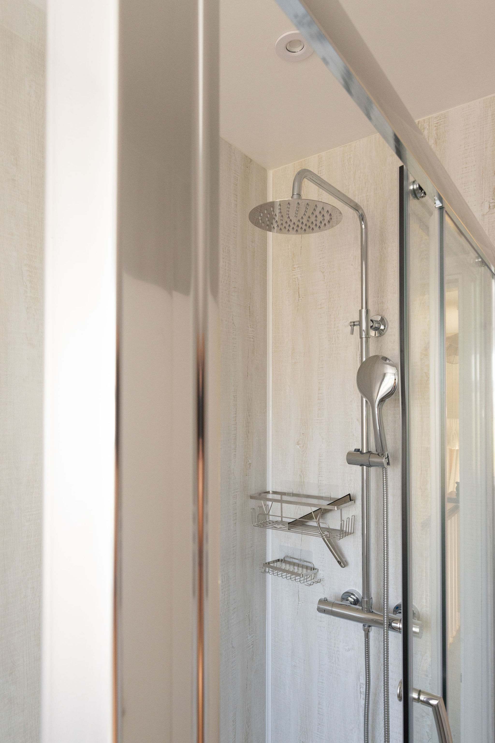 The family shower room offers a rainfall shower and handheld shower head.