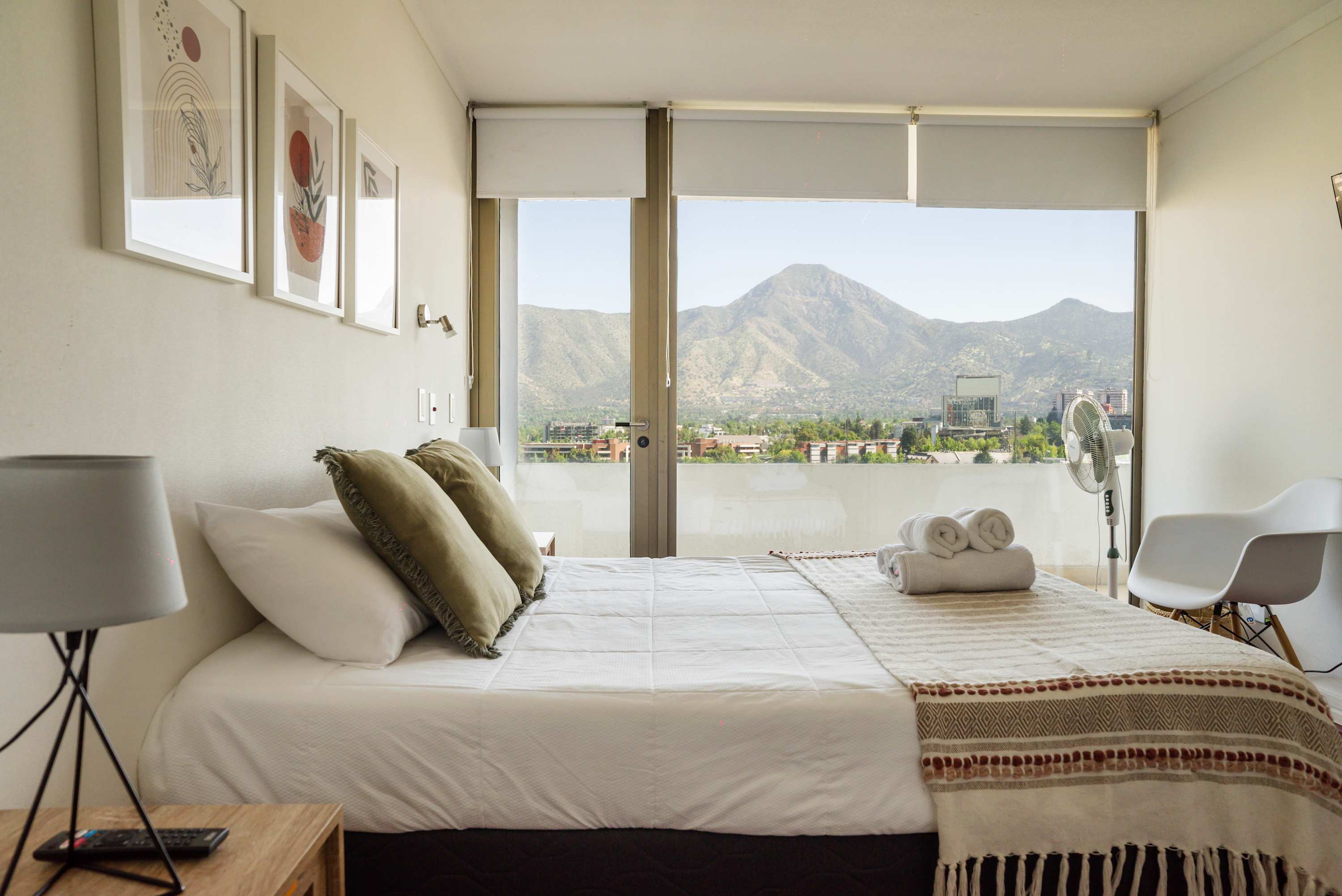 Relax in a cozy bedroom with breathtaking mountain views, perfect for unwinding after a day of exploring.