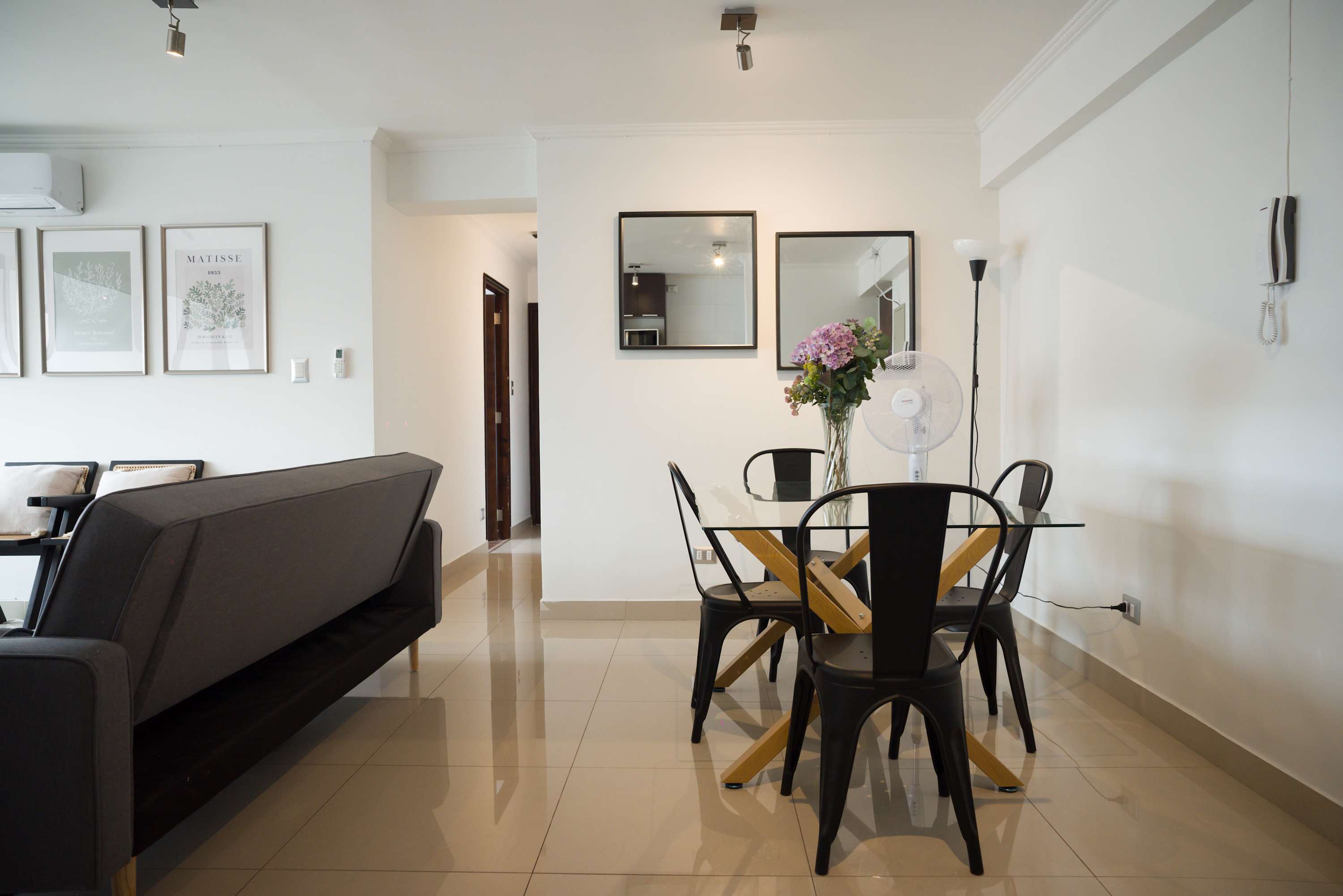Modern dining area with stylish decor and natural light, perfect for family meals.