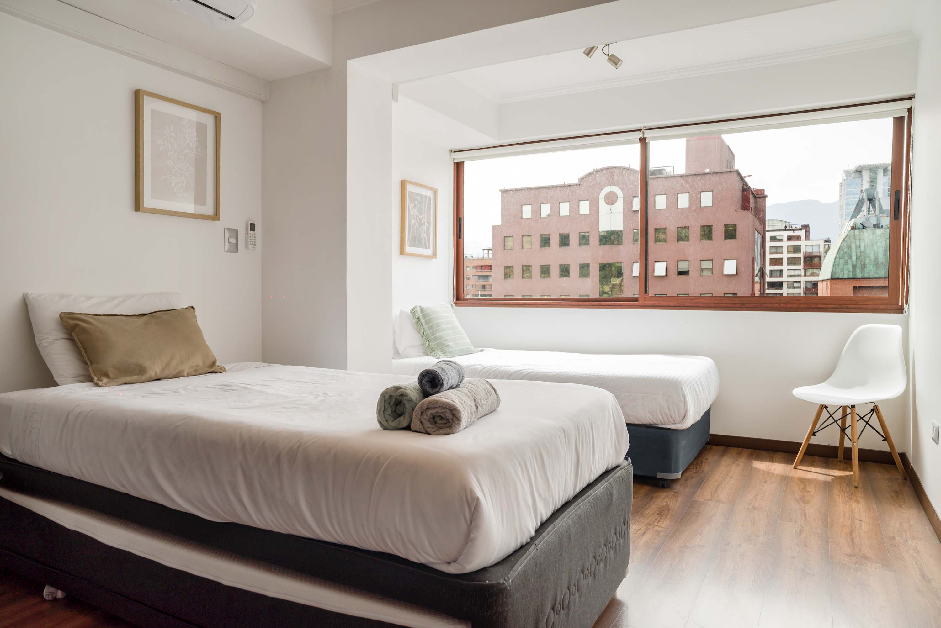 Bright and airy bedroom with city views, perfect for relaxation after exploring the city.