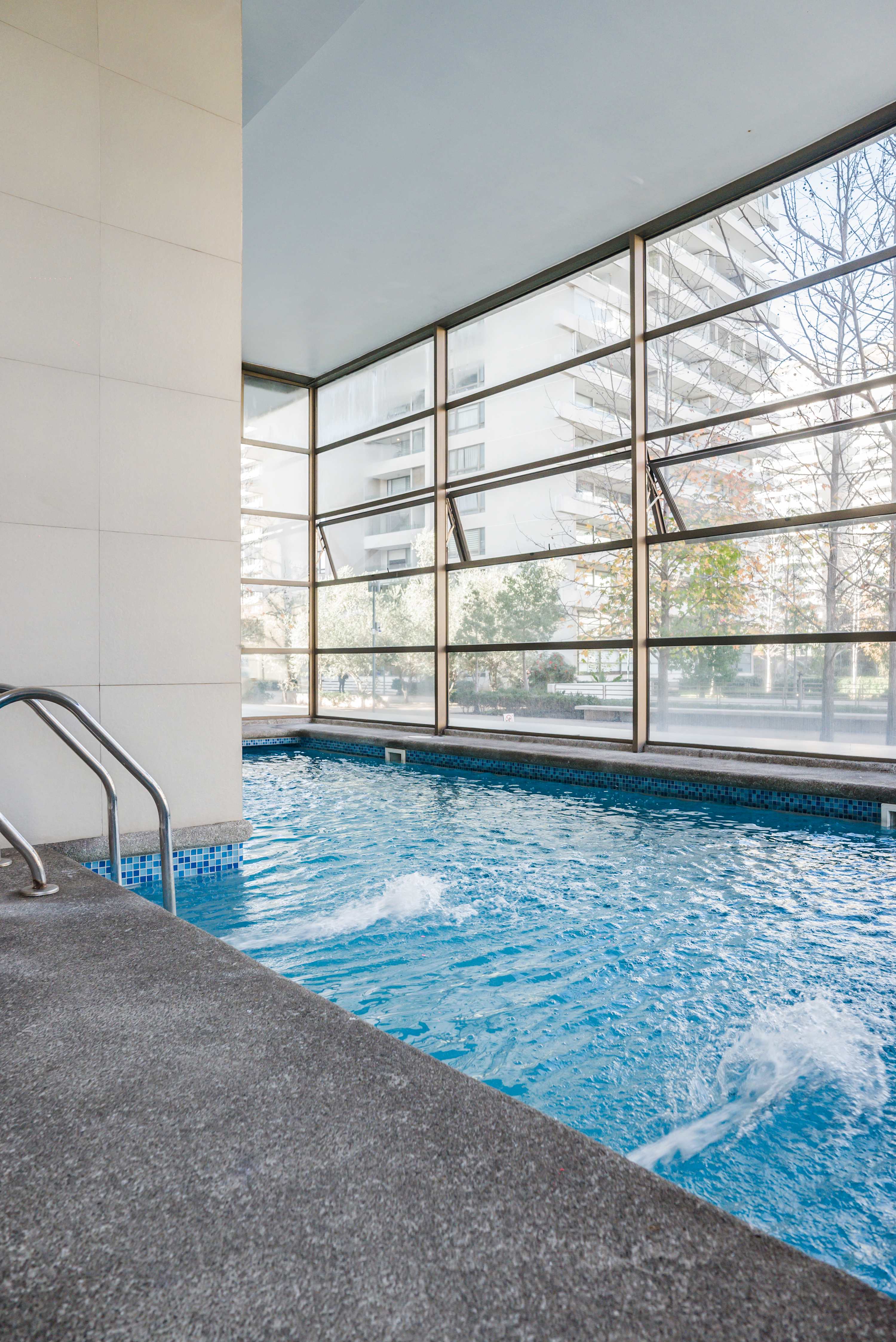 Enjoy a refreshing swim in the bright and inviting indoor pool. (Common Area)