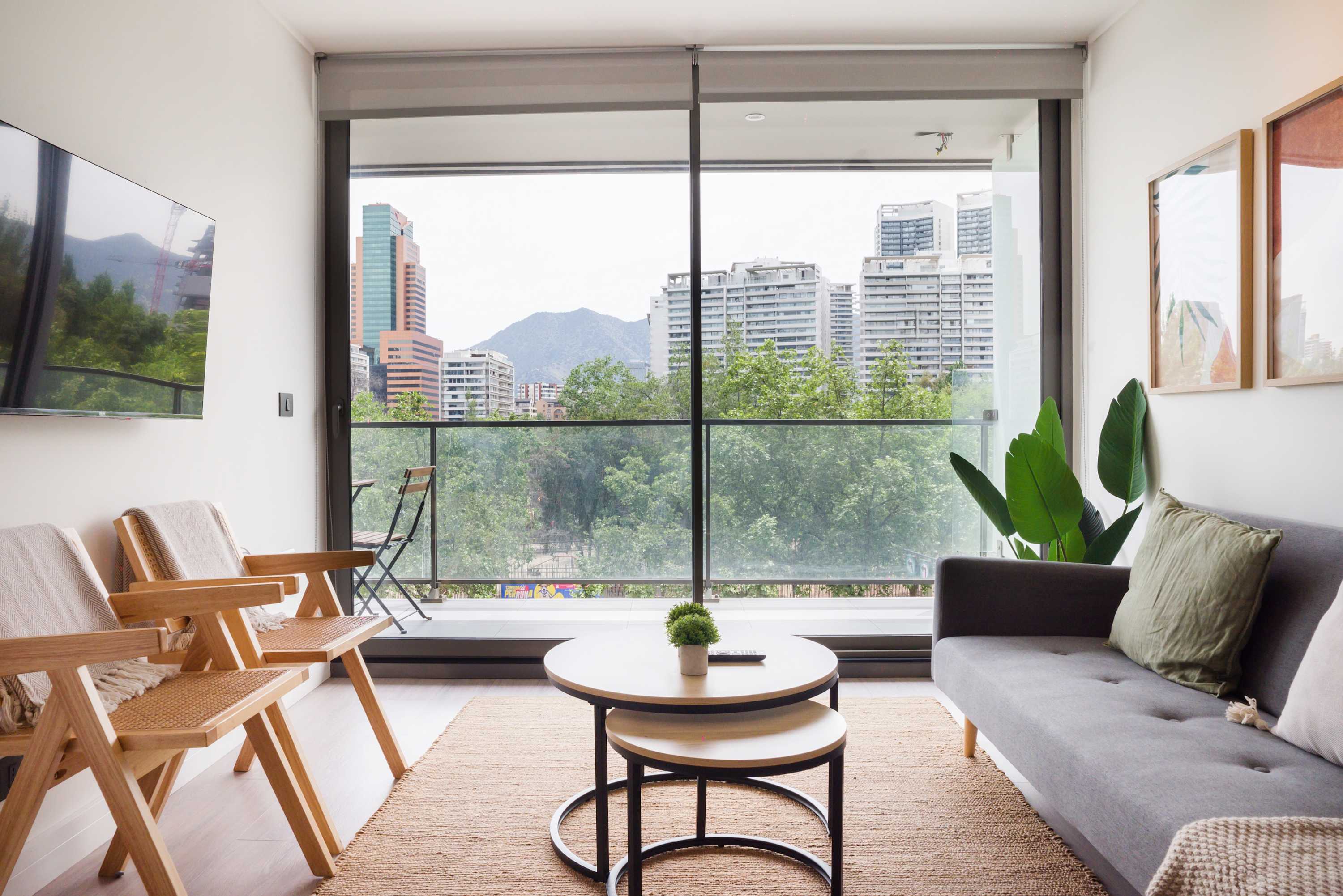Enjoy stunning city and mountain views from this chic living room, perfect for relaxation and unwinding.