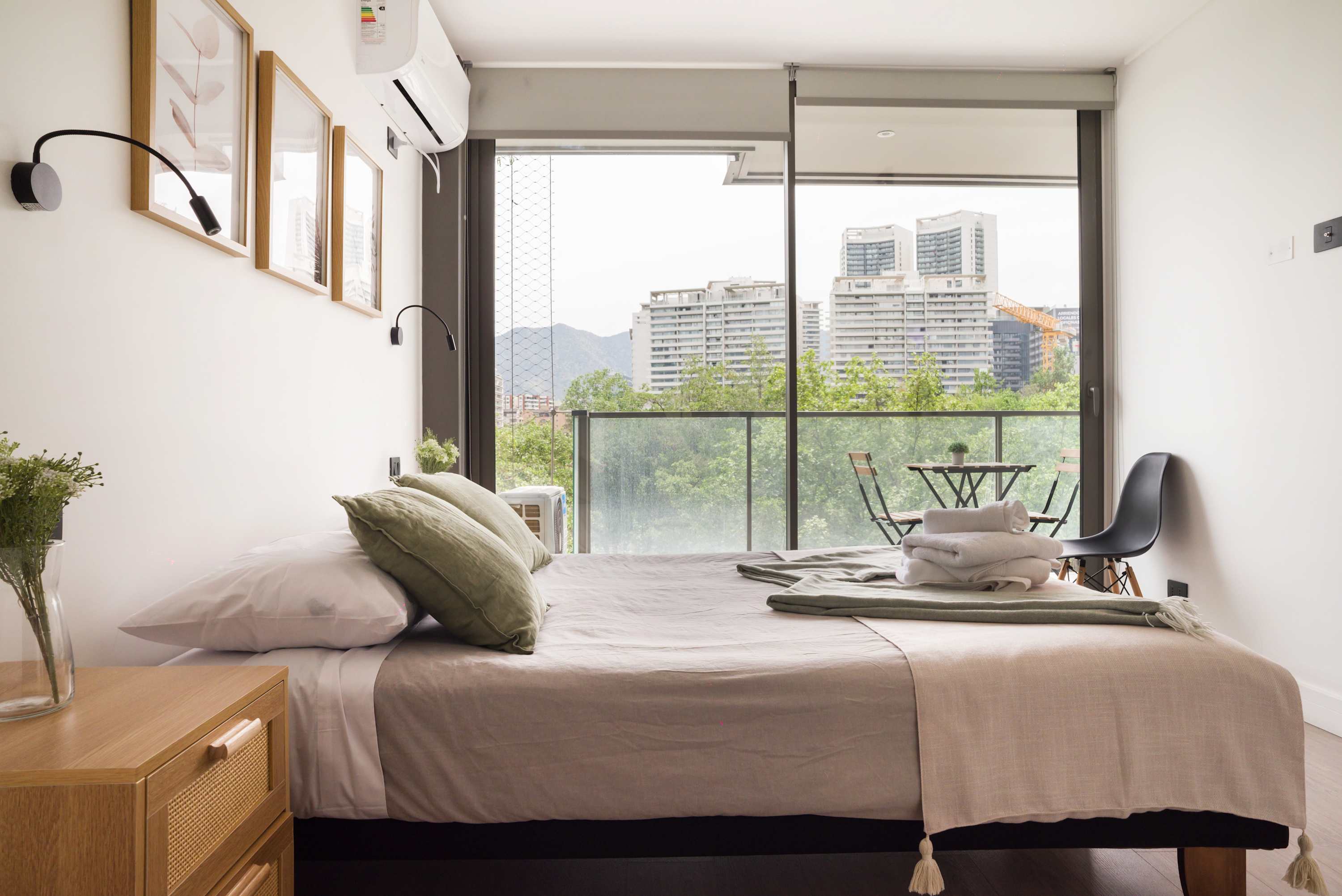Relax in this bright bedroom with stunning city and mountain views from your private balcony.