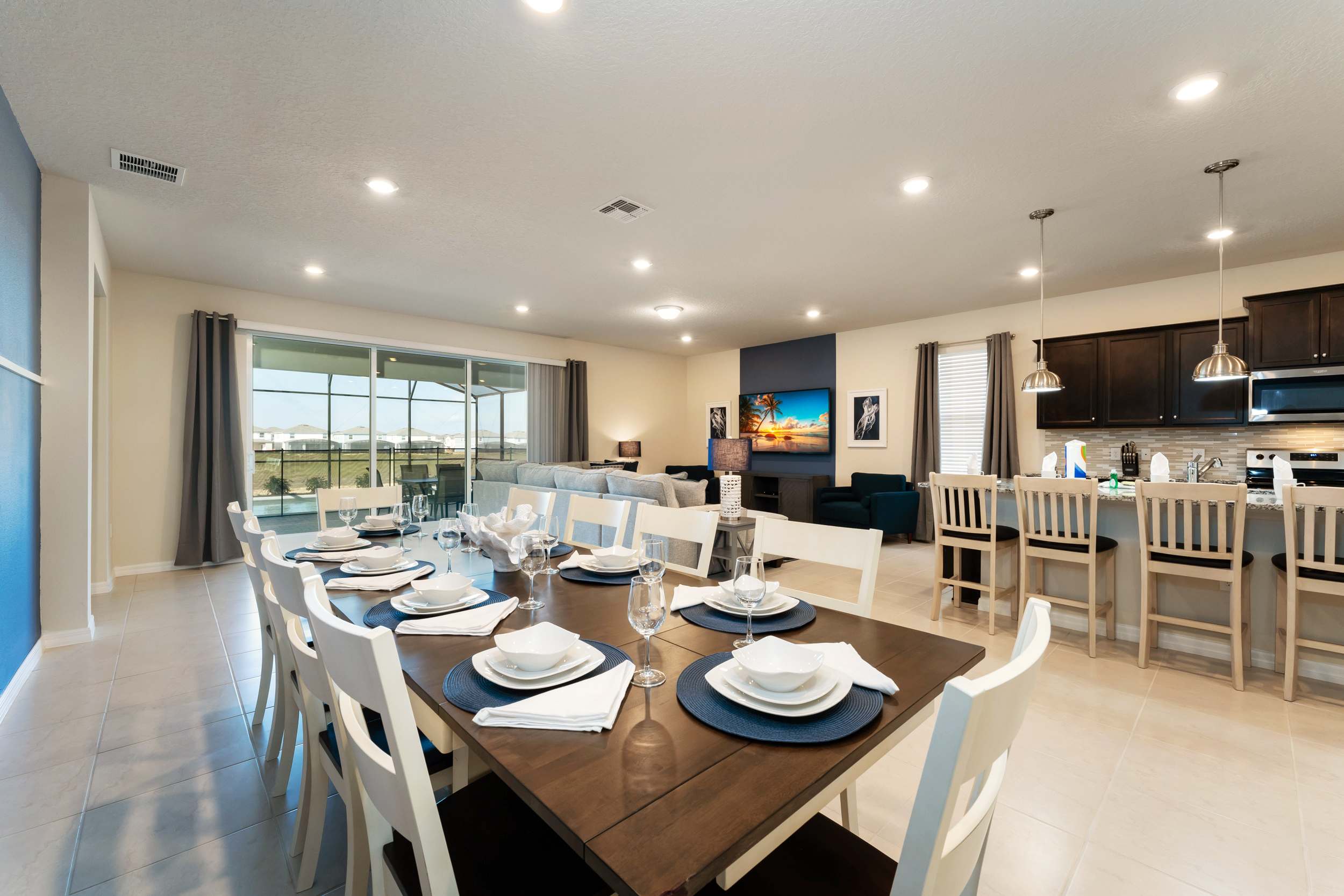 Elegant open-plan dining and living area with modern amenities and a seamless flow to the outdoor space, perfect for entertaining.