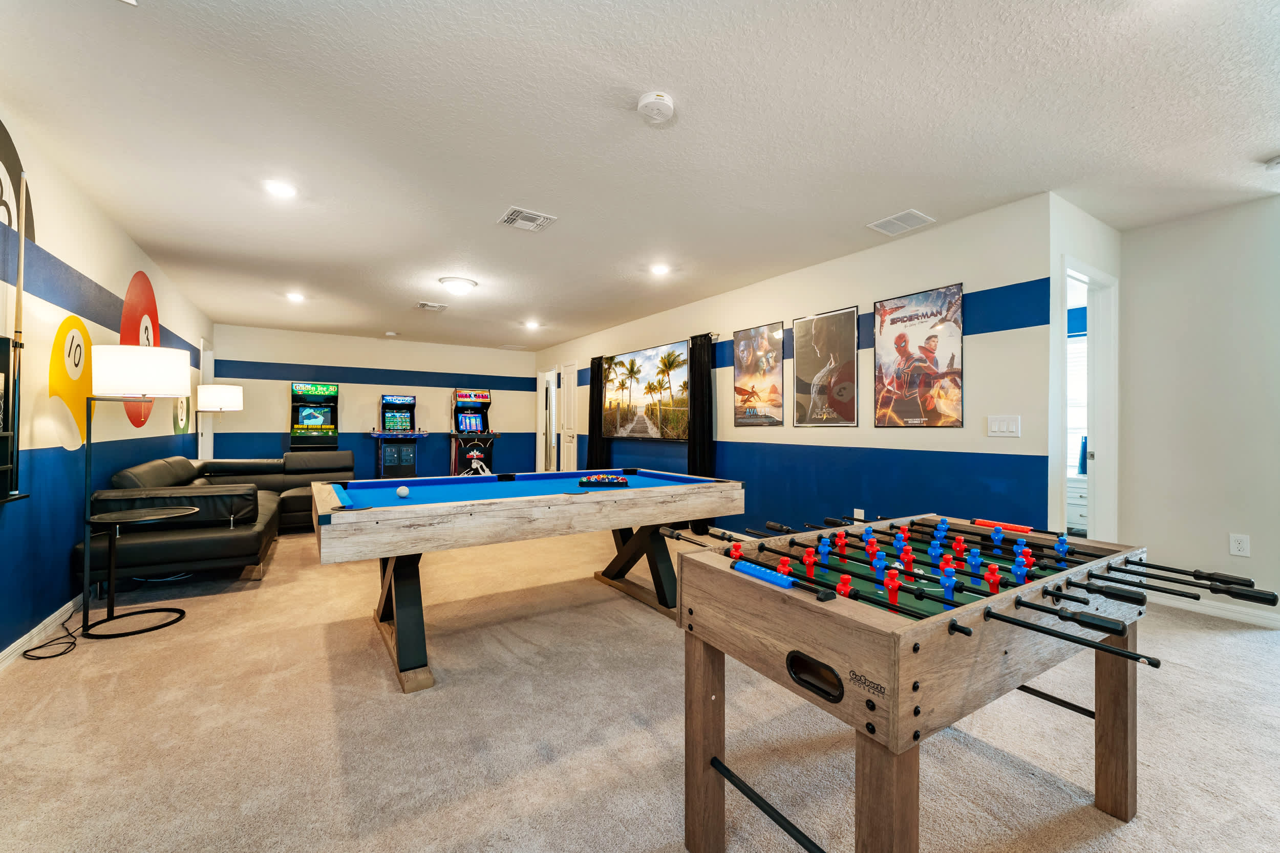 Enjoy endless fun in this vibrant game room with pool, foosball, and arcade games, perfect for entertaining guests.
