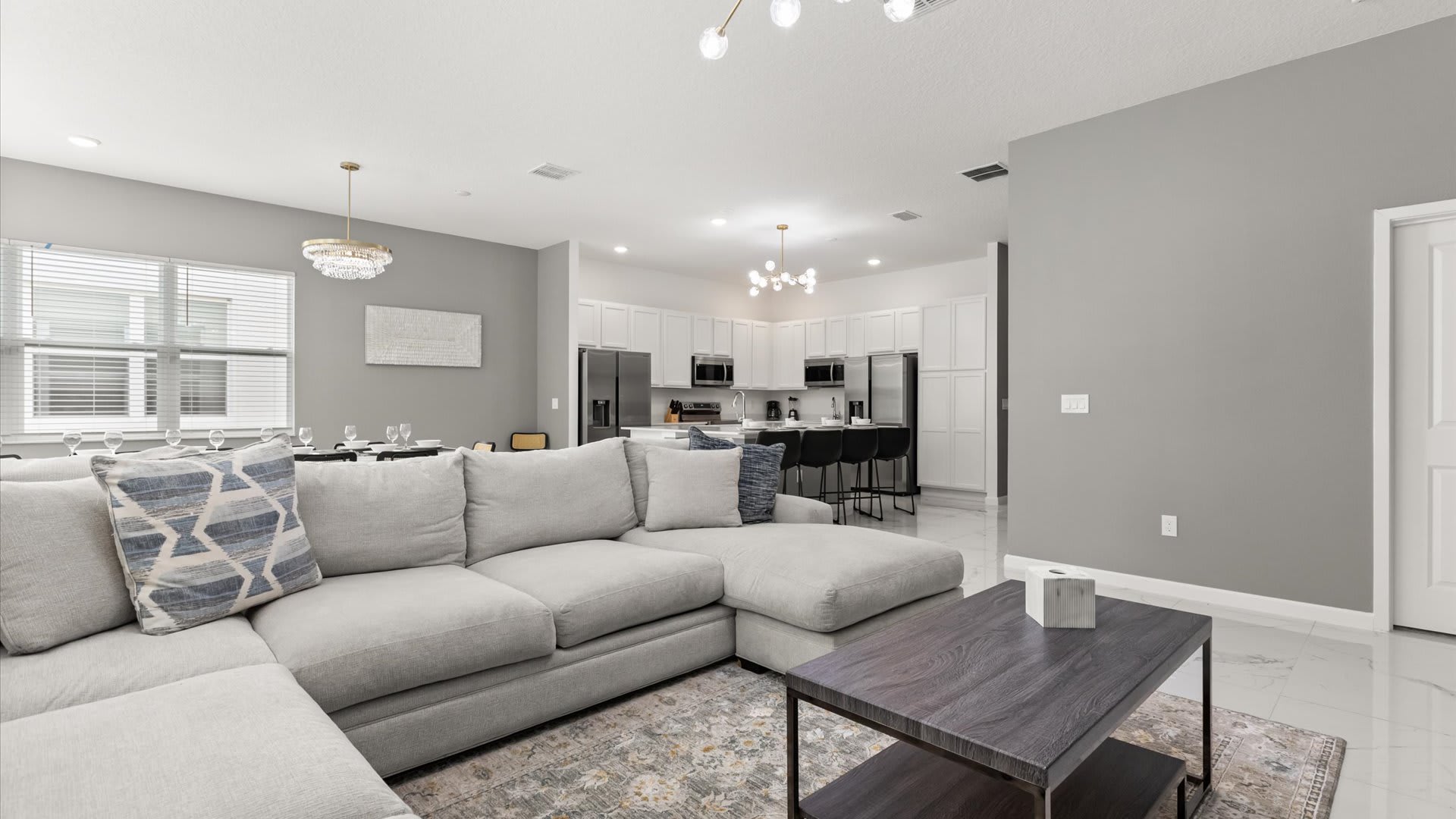 Living Room: Bright, spacious living area perfect for movie nights and family gatherings featuring plush seating, a large Smart TV, and natural light.