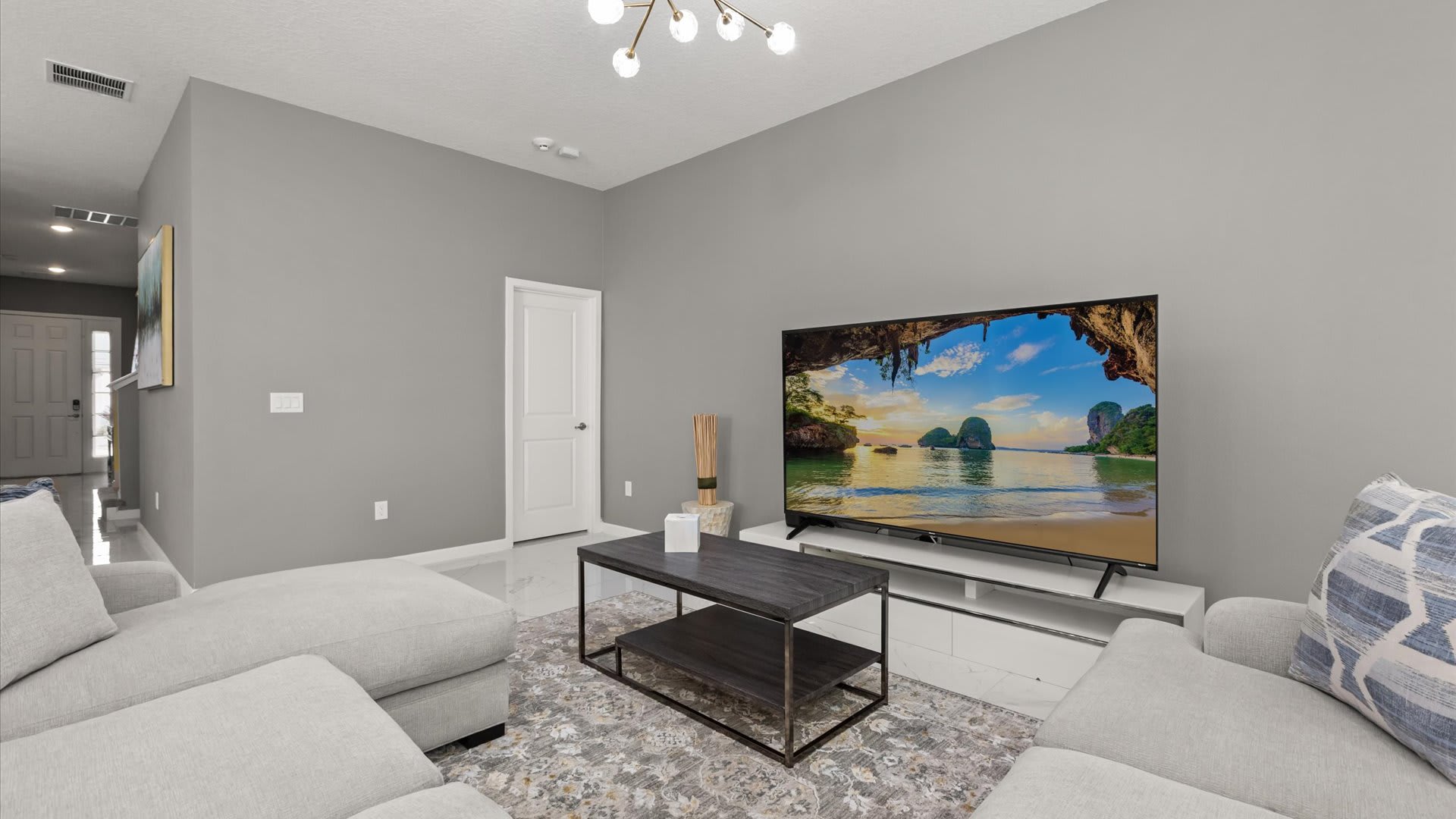 Living Room: Bright, spacious living area perfect for movie nights and family gatherings featuring plush seating, a large Smart TV, and natural light.