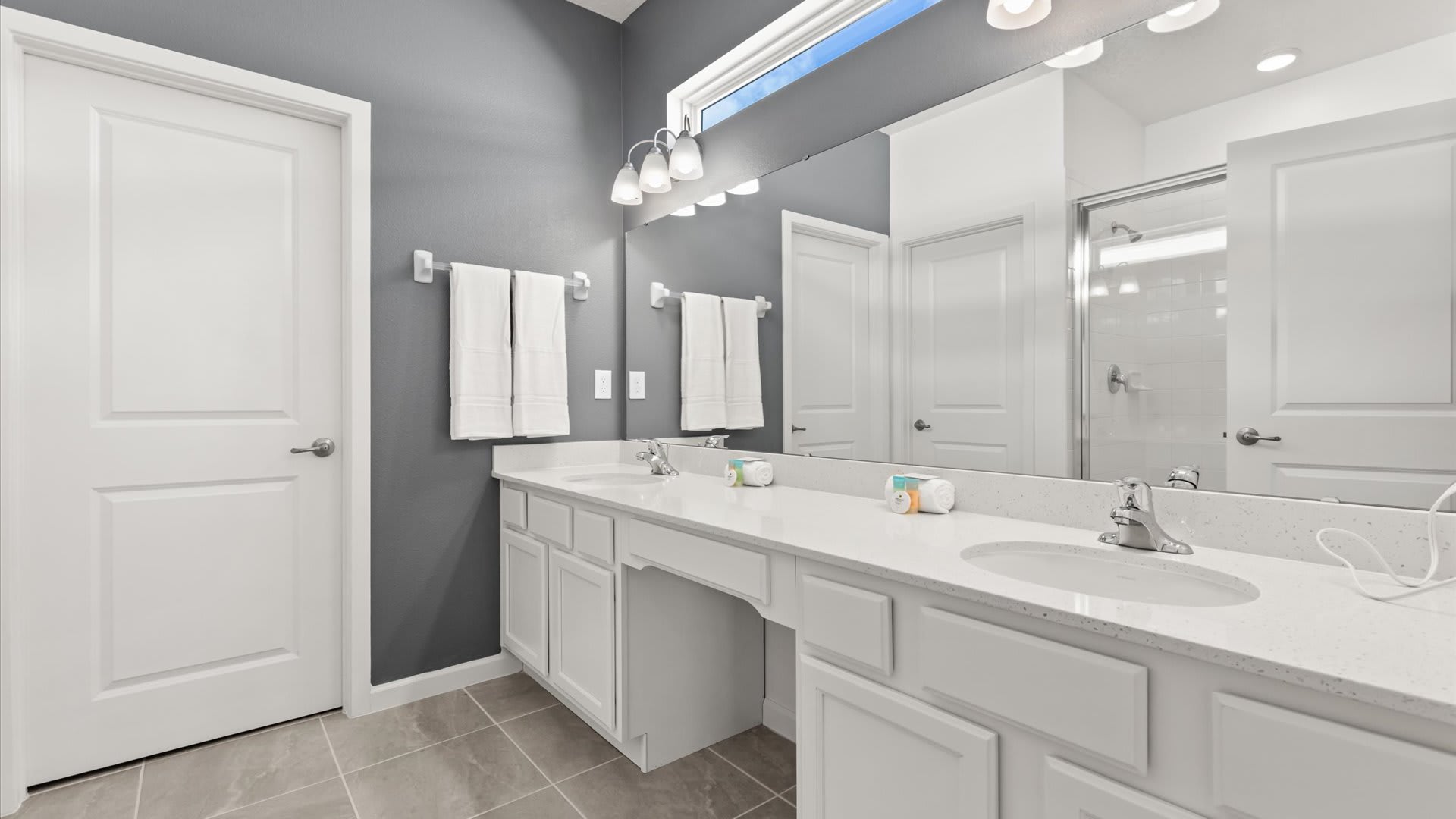 Master En-Suite Bathroom: Spacious bathroom with a walk-in shower and clean, minimalist design for a comfortable stay.