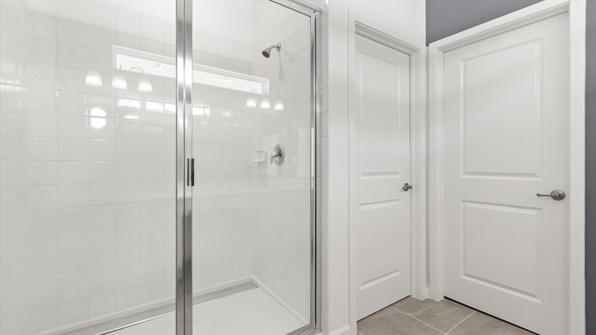 Master En-Suite Bathroom: Spacious bathroom with a walk-in shower and clean, minimalist design for a comfortable stay.