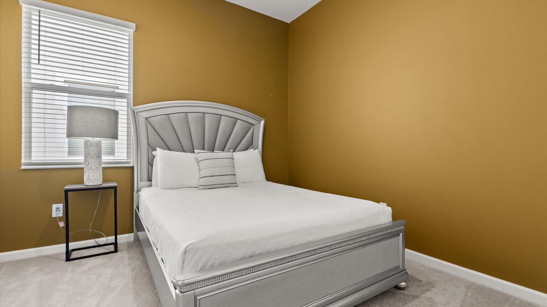 Bedroom 7: Queen Bedroom with warm golden tones and a queen-sized bed makes this room feel peaceful and homely — ideal for a good night’s rest.