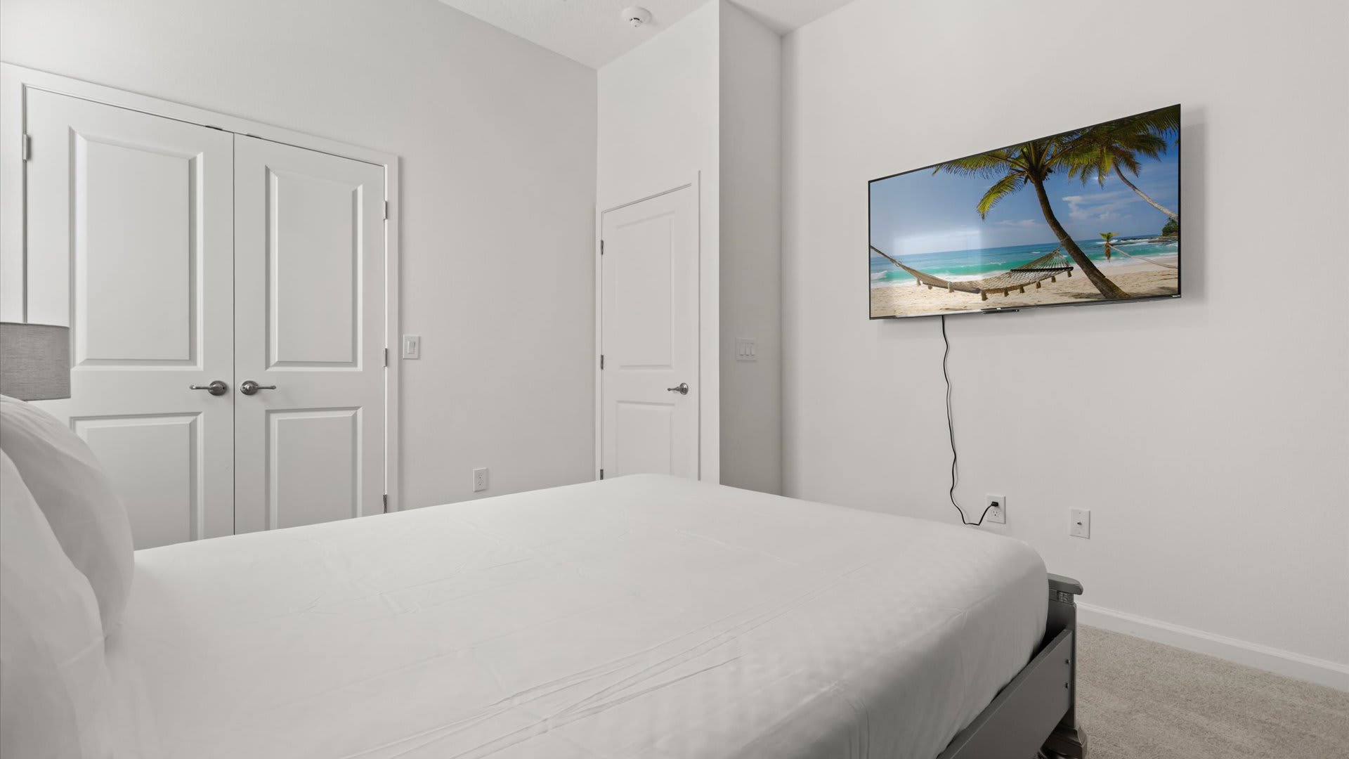 Bedroom 9: Queen Bedroom with cool blue accents, a smart TV, and modern decor creates a tranquil retreat for restful nights.